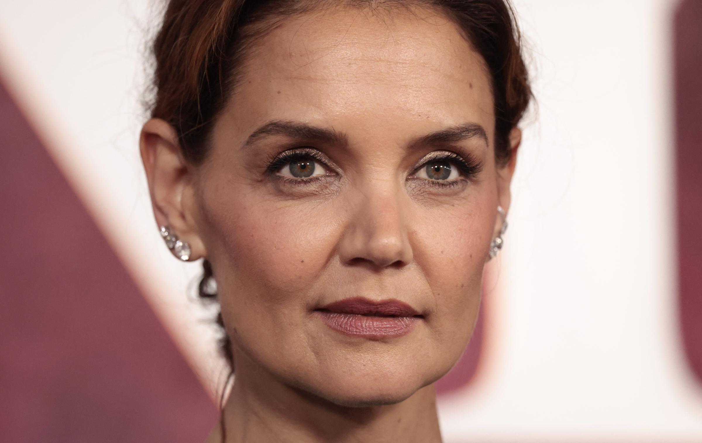 Katie Holmes attends the 78th Annual Tony Awards in New York City wearing crystal earrings and soft glam makeup, posing confidently at Radio City Music Hall on June 8, 2025.