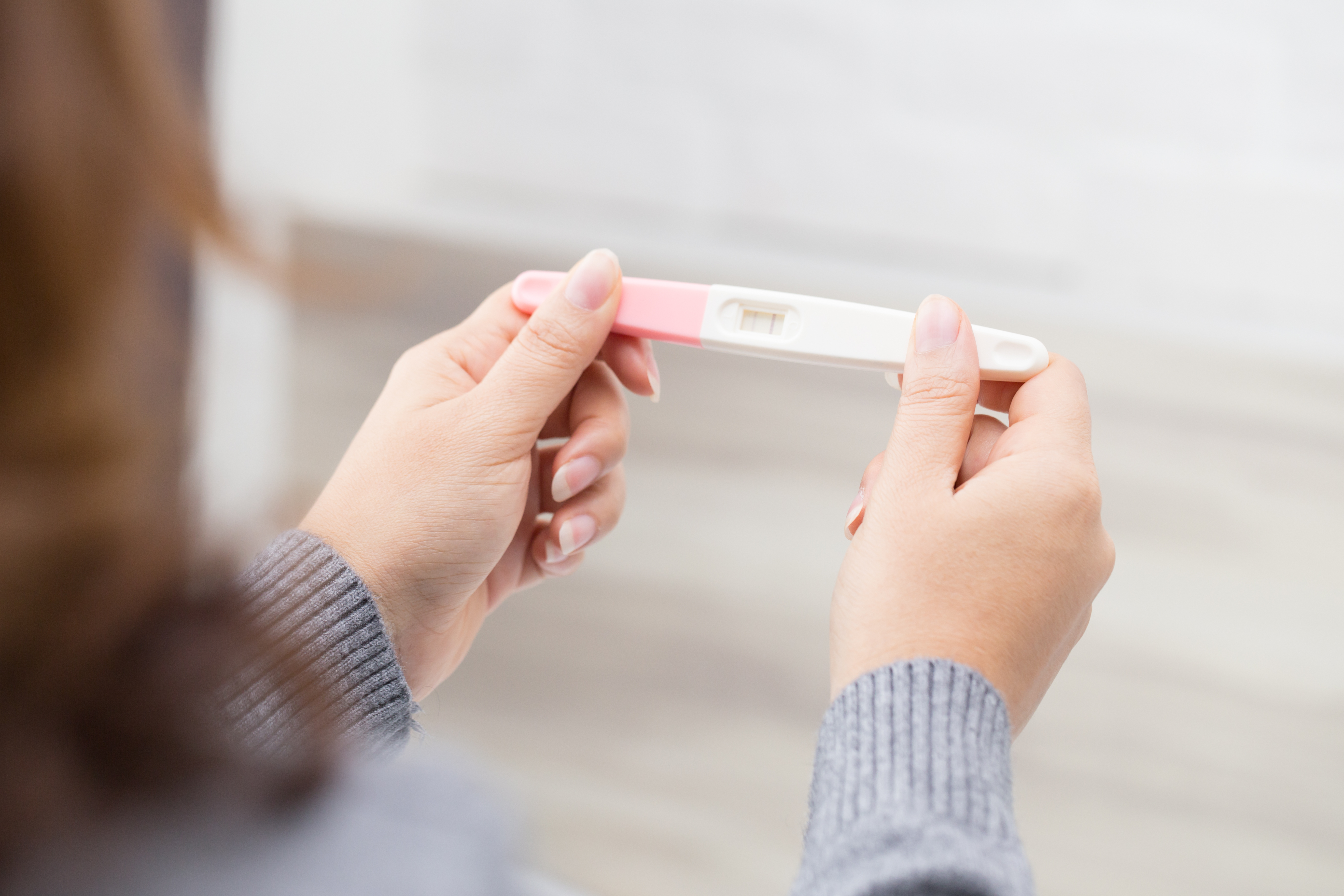 Woman holding pregnancy test | Source: Shutterstock