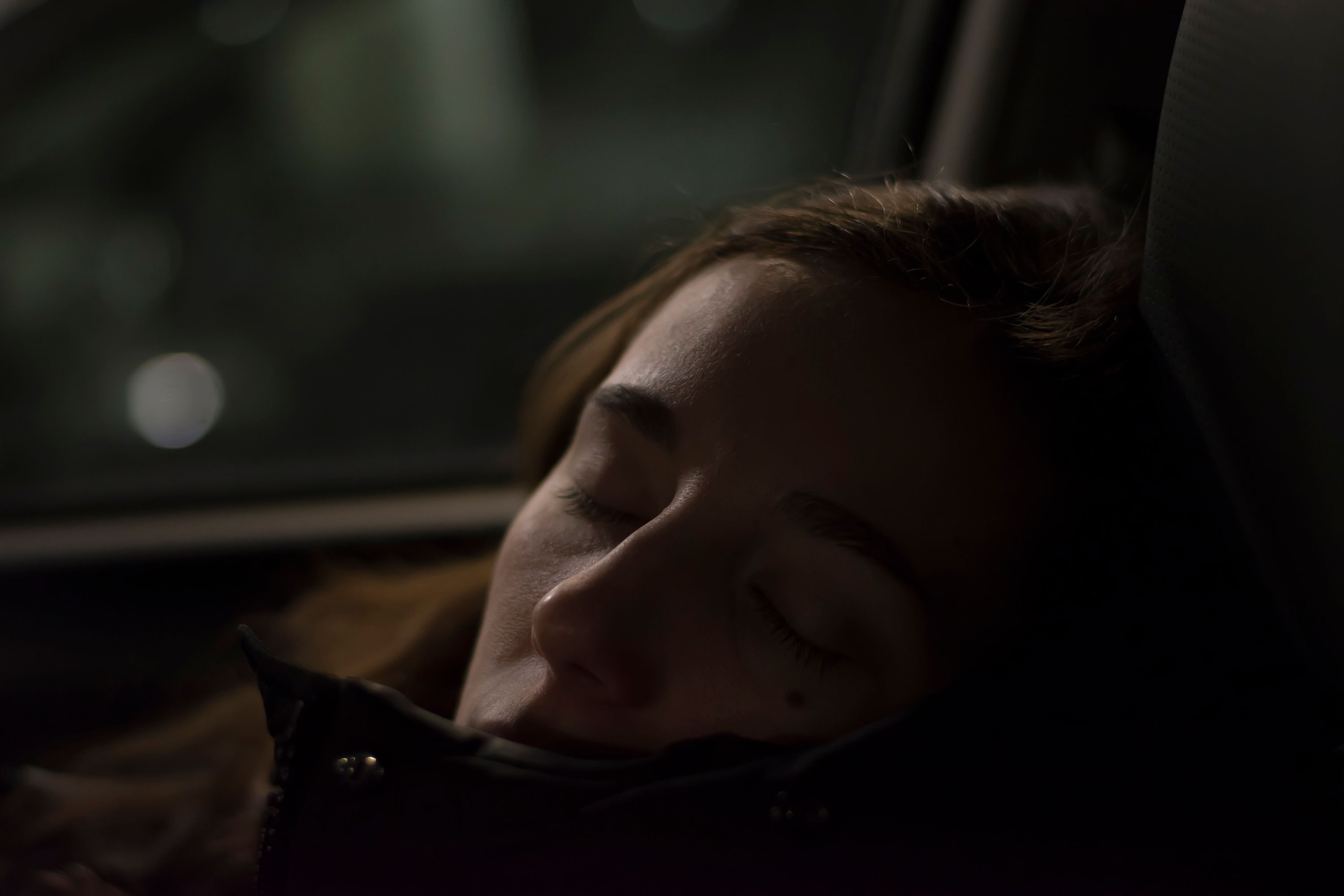 Attractive lady sleeping on passenger seat in the car | Source: Shutterstock.com