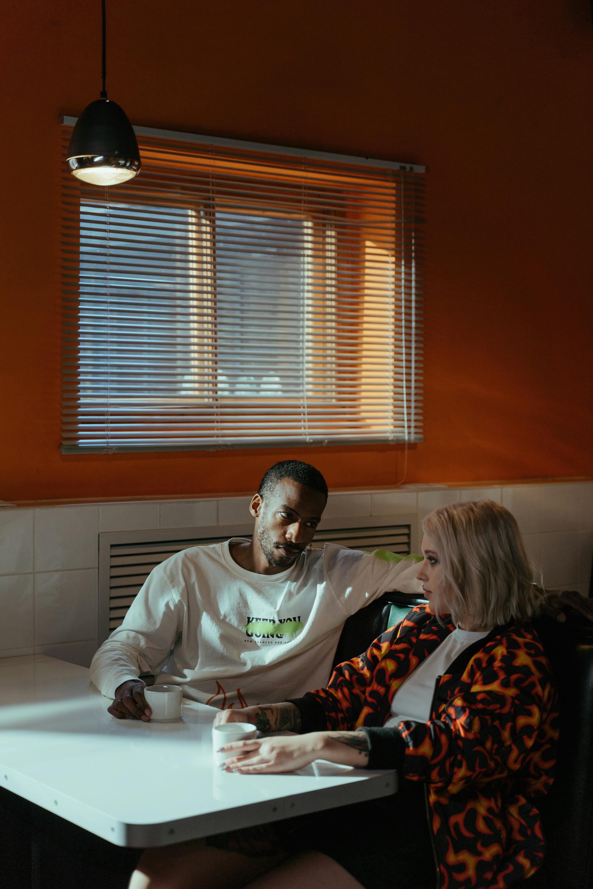 A couple having coffee while talking | Source: Pexels