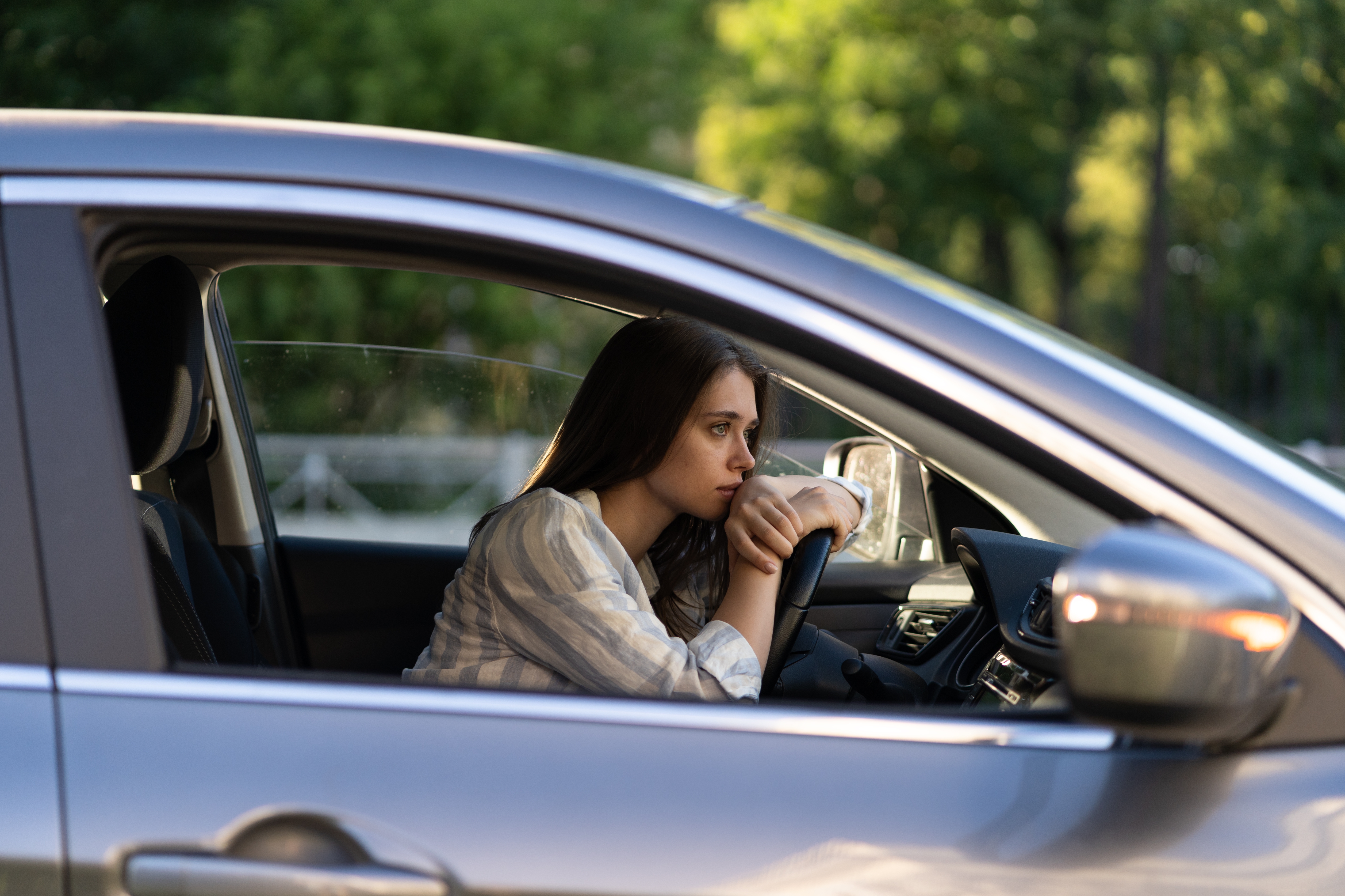 Depressed young woman driver | Source: Shutterstock
