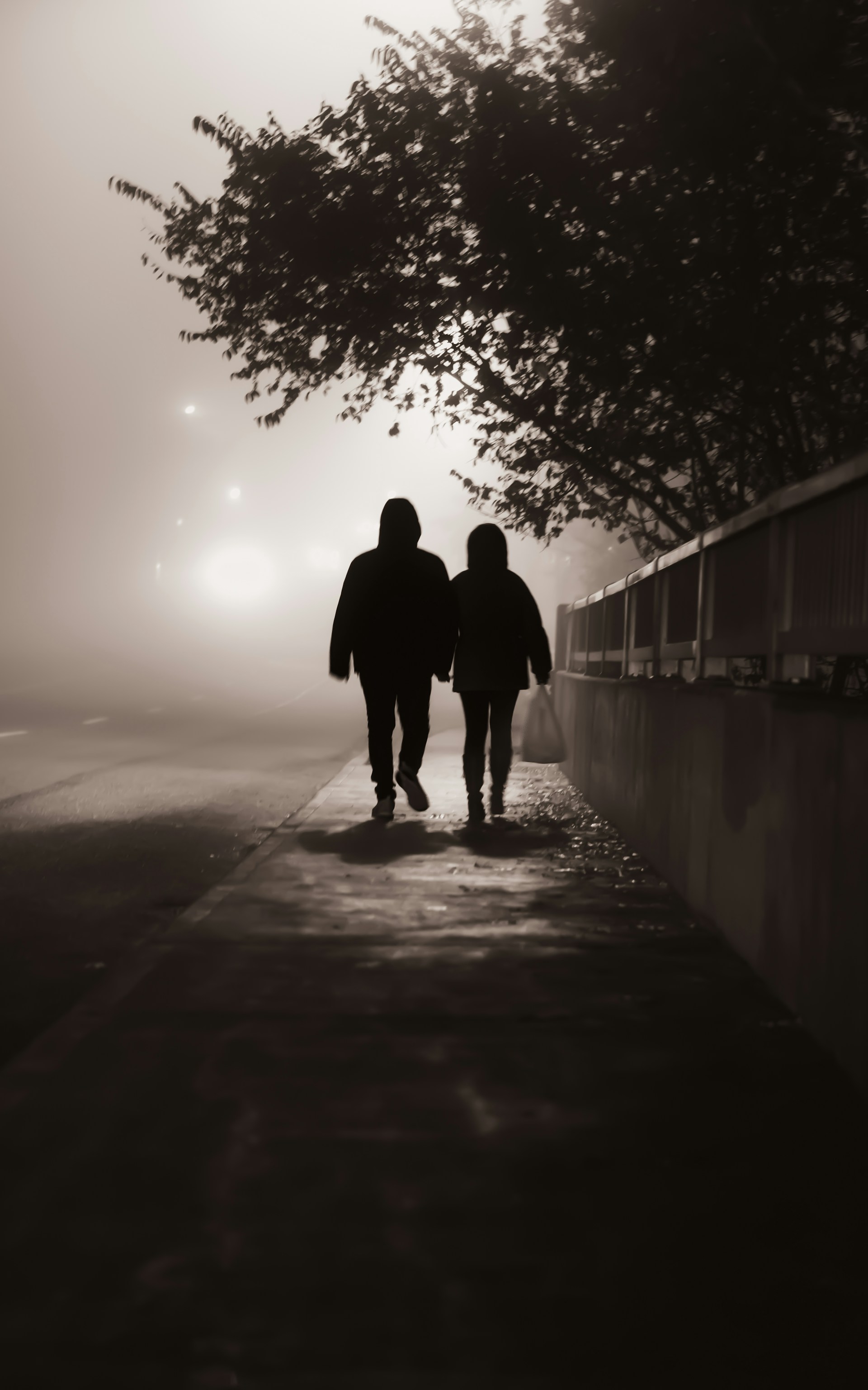 Silhouette of two people walking on the street | Source: Unsplash