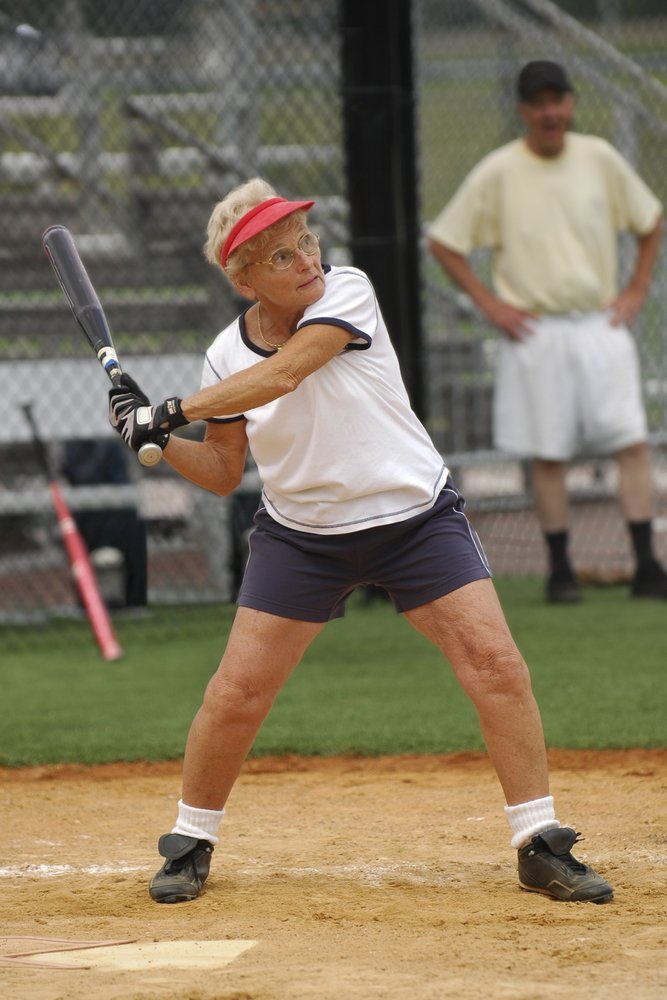 Senior woman at bat in softball game. | Source: Shutterstock
