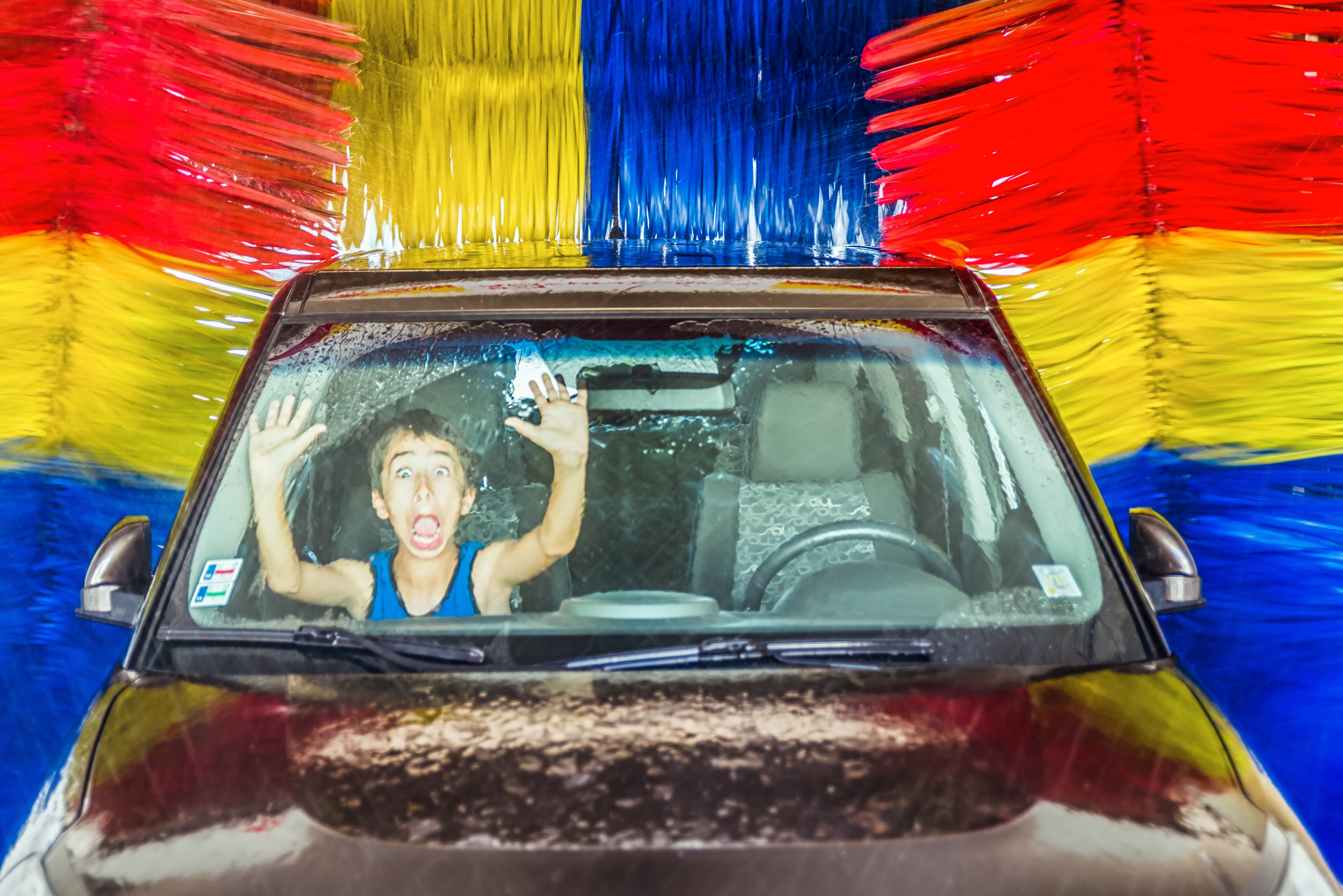 Boy in a car at automatic car wash | Source: Shutterstock