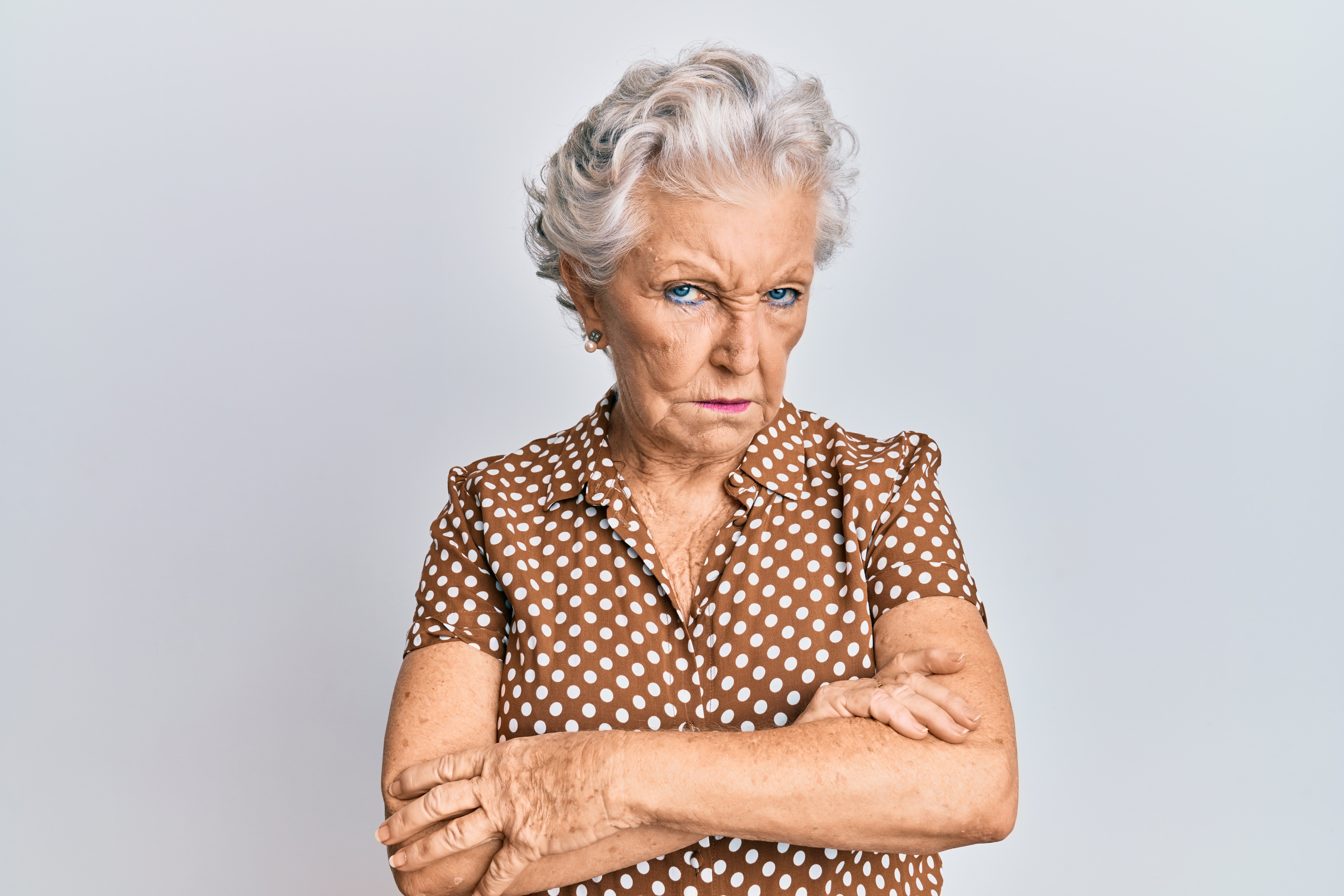 An elderly woman with a disapproving stare. | Source: Shutterstock 