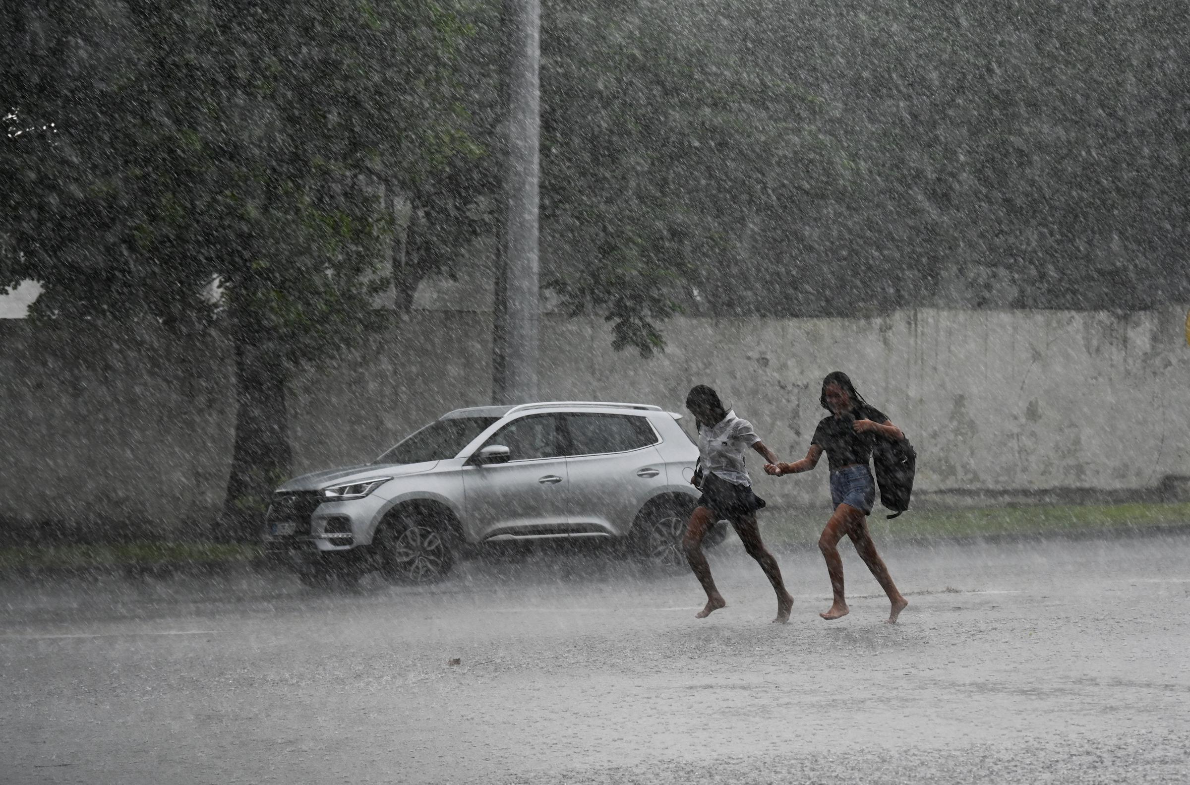 People run in torrential rain in Havana due to the passage of Hurricane Milton on October 9, 2024 | Source: Getty Images