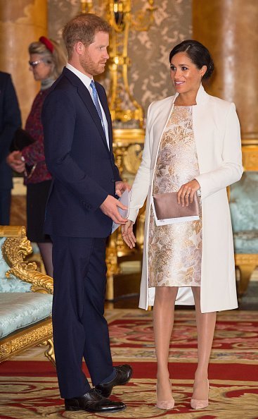 Meghan and Prince Harry attend a reception to mark the fiftieth anniversary of the investiture of the Prince of Wales at Buckingham Palace on March 5, 2019, in London, England. | Source: Getty Images.