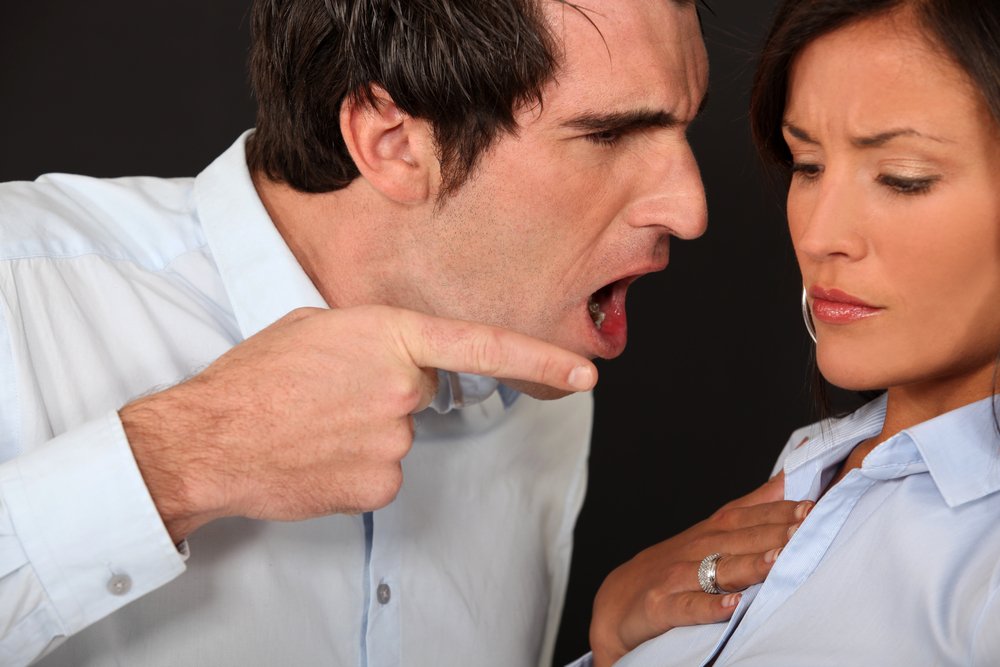 A man gets in a woman's face, points at her with a finger, and shouts angrily | Photo: Shutterstock/Phovoir
