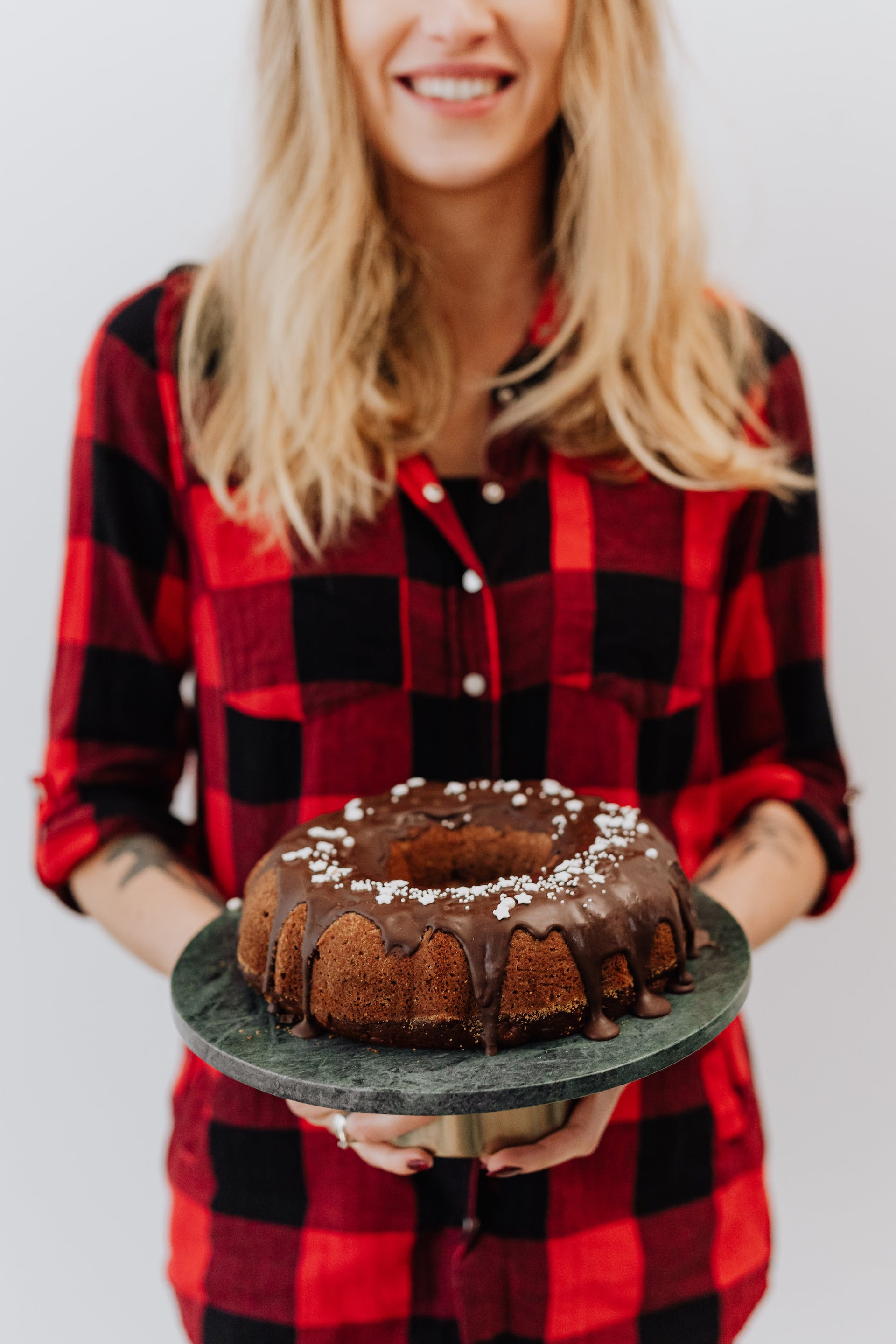 A woman holding a chocolate cake | Source: Pexels