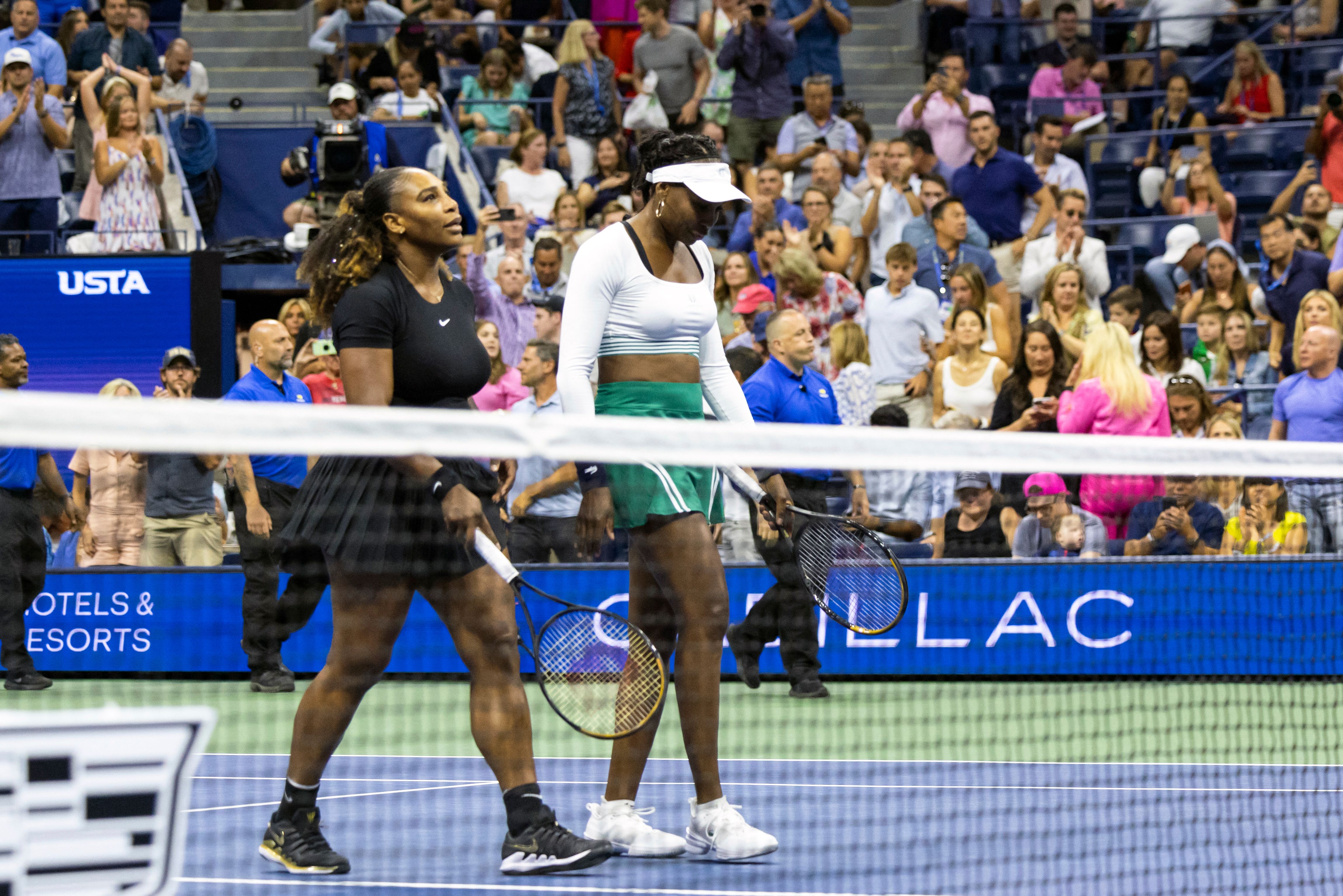 Serena and Venus Williams leave the court after their doubles loss at the 2022 US Open in New York on September 1. | Source: Getty Images