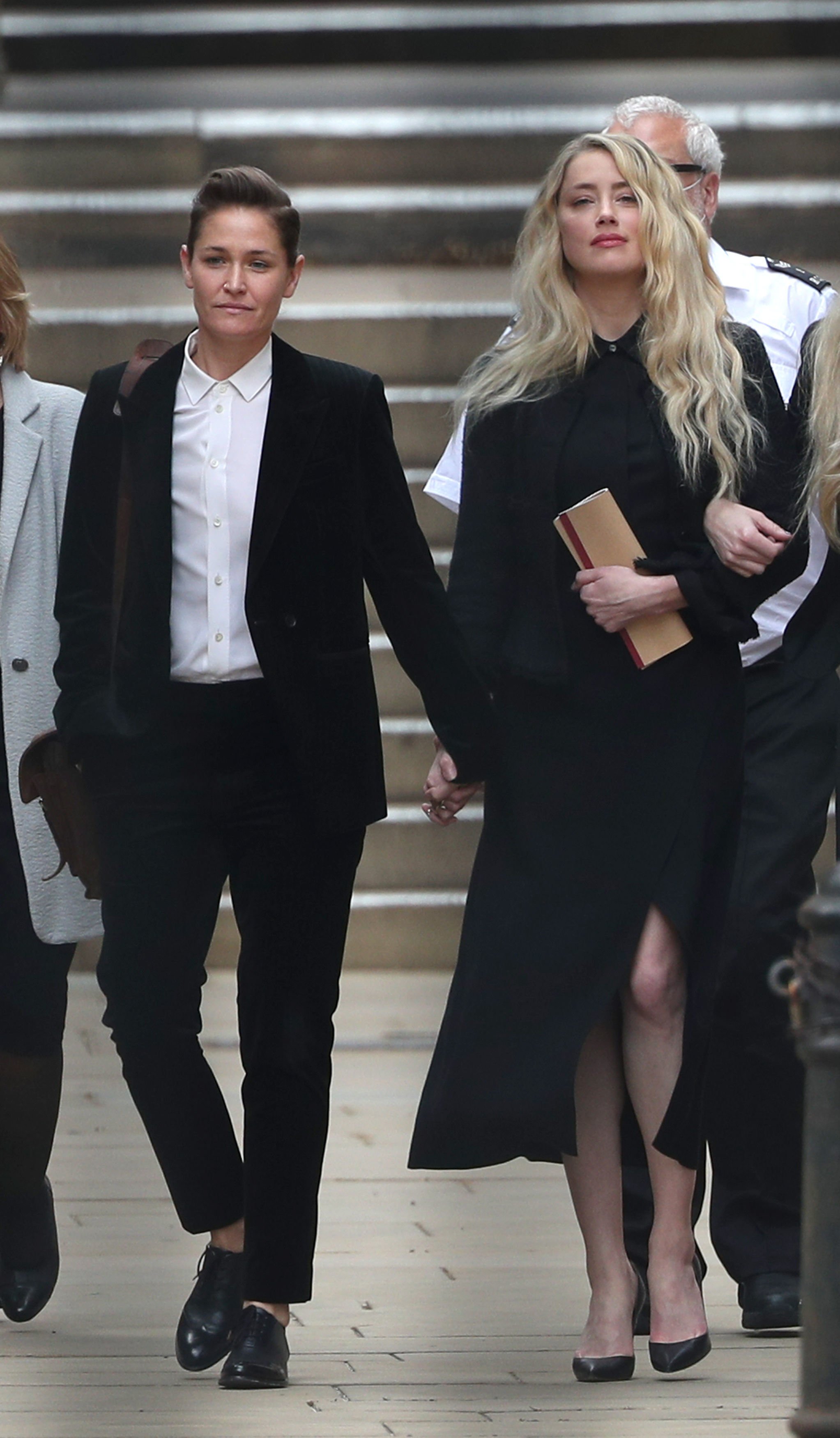 Actress Amber Heard (right) with girlfriend Bianca Butti leaves the High Court in London on July 27 2020 | Source: Getty Images