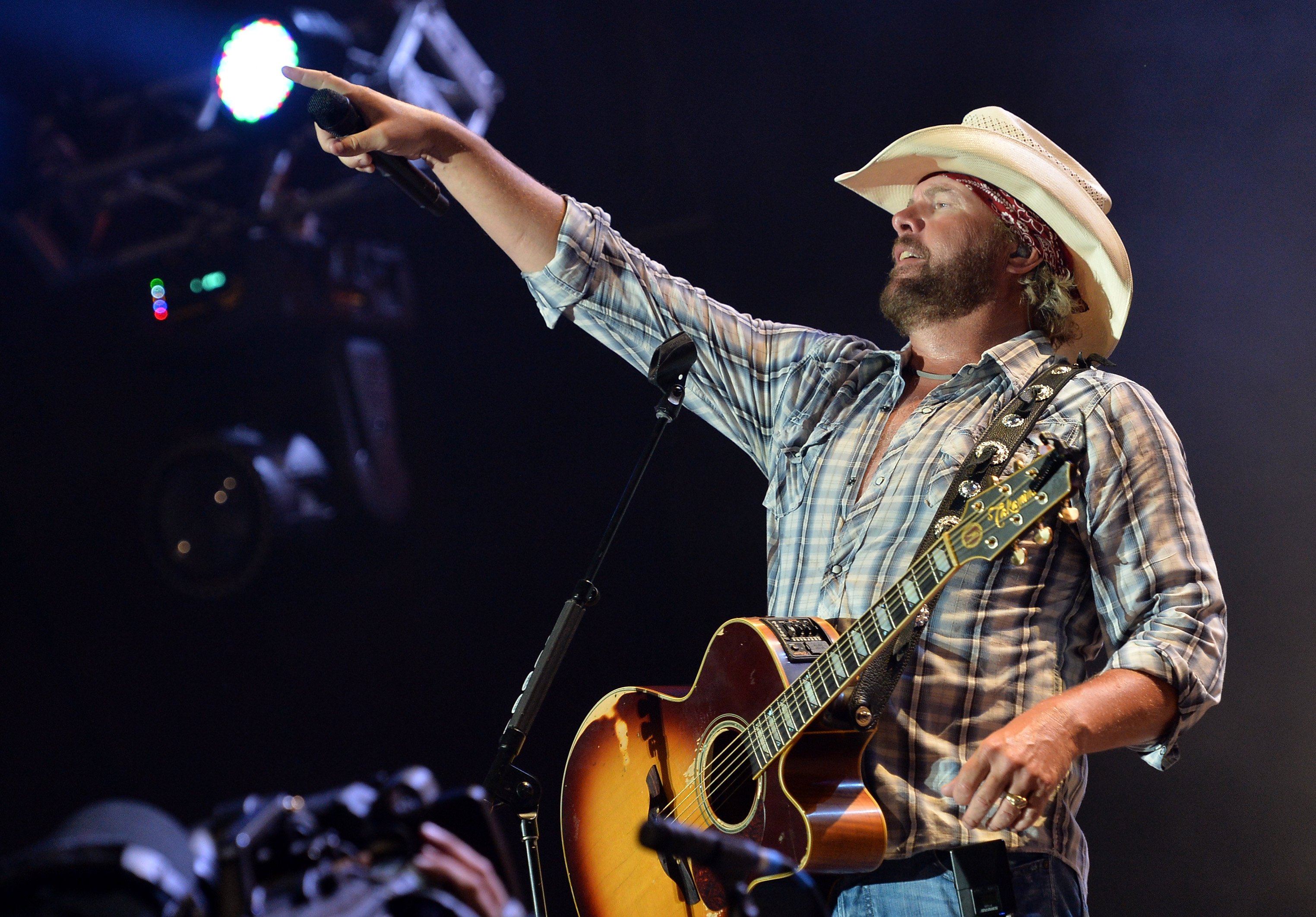Toby Keith performs during the Oklahoma Twister Relief Concert to benefit United Way of Central Oklahoma May Tornadoes Relief Fund at Gaylord Family Oklahoma Memorial Stadium on July 6, 2013 in Norman, Oklahoma | Source: Getty Images