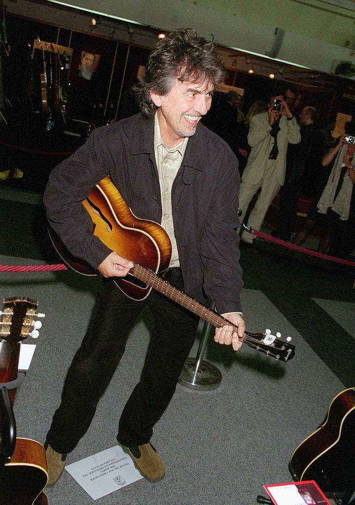 Musician George Harrison plays some of the guitars on offer at Christie's Auction on June 24 at Christie's | | Getty Images / Global Images Ukraine Musician George Harrison plays some of the guitars on offer at Christie's Auction on June 24 at Christie's | | Getty Images / Global Images Ukraine