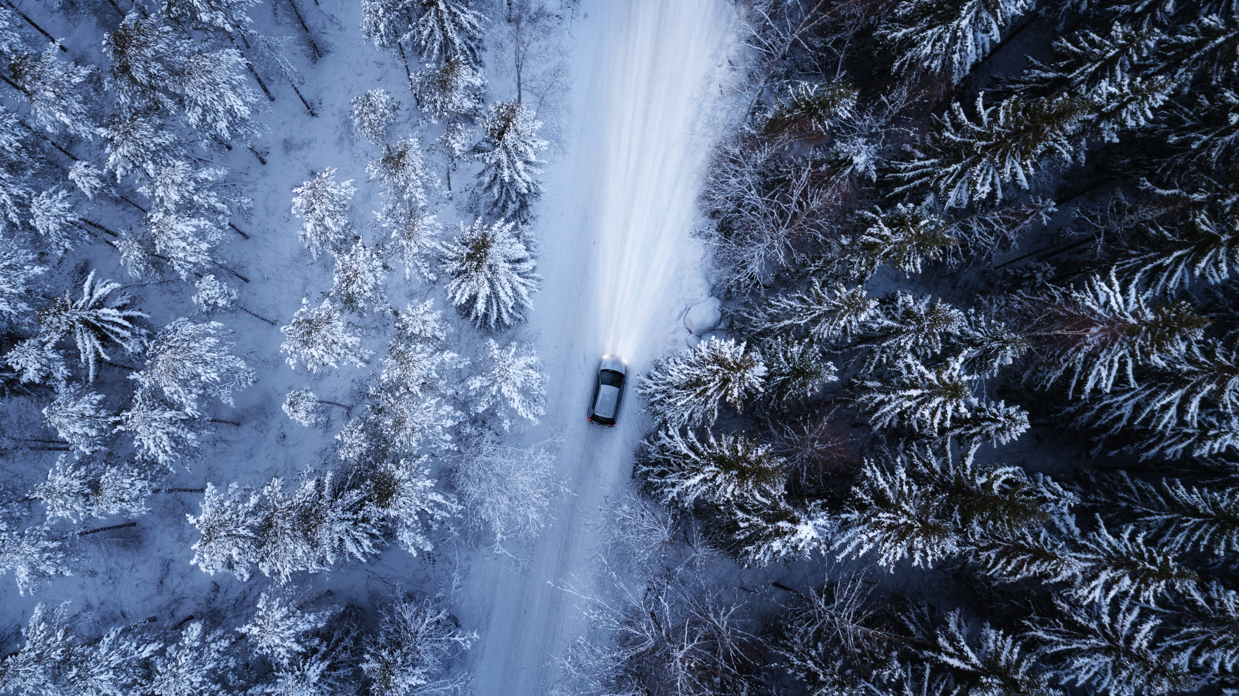 Aerial view of a car on winter road | Source: Shutterstock