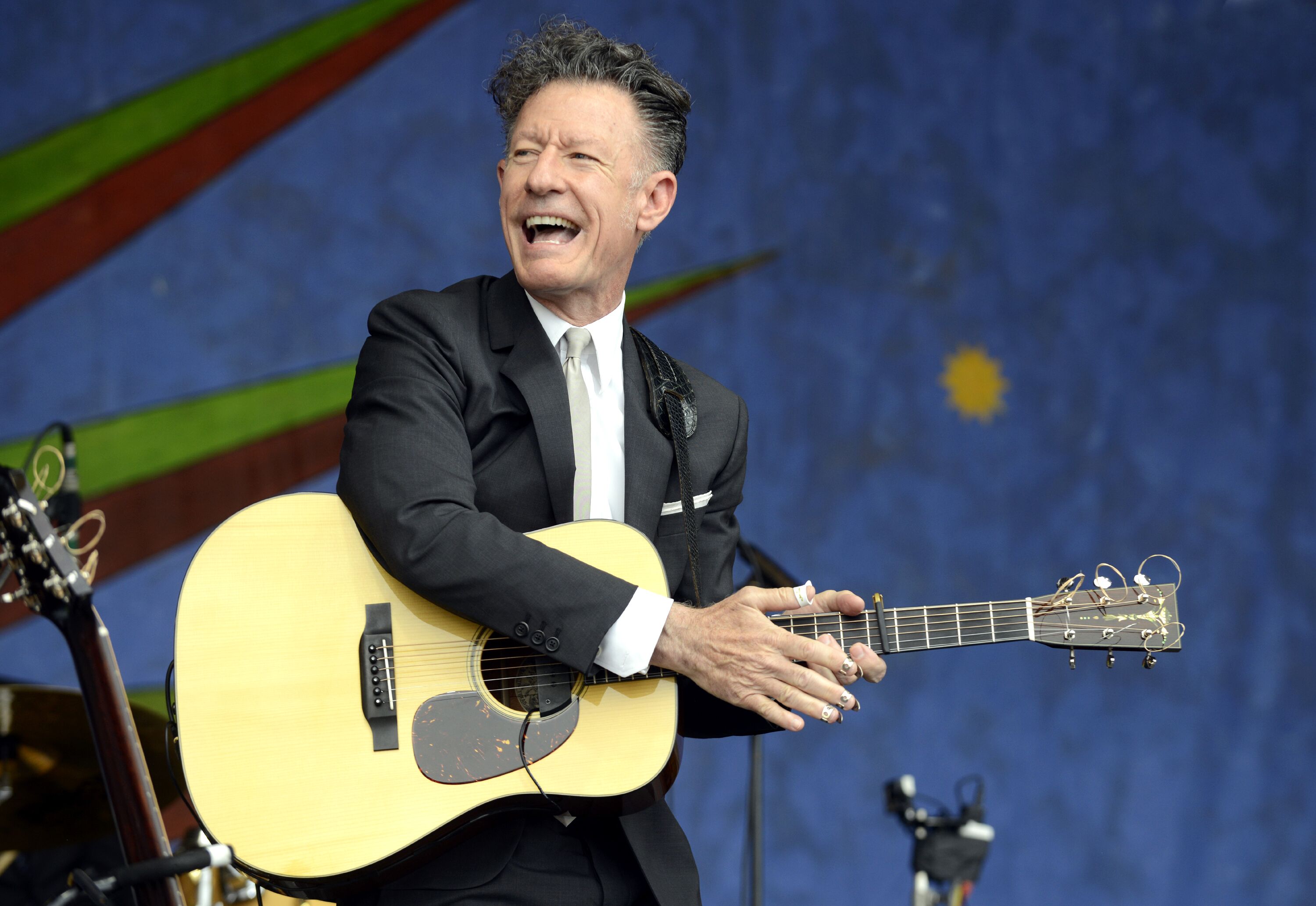 Lyle Lovett performs during Day 4 of the 2014 New Orleans Jazz & Heritage Festival at Fair Grounds Race Course on May 1, 2014 in New Orleans, Louisiana. | Source: Getty Images