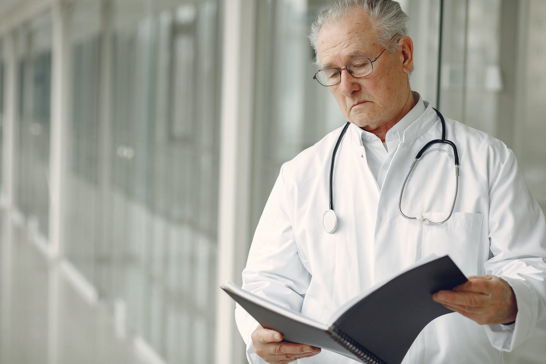 Doctor looking at a folder | Source: Pexels