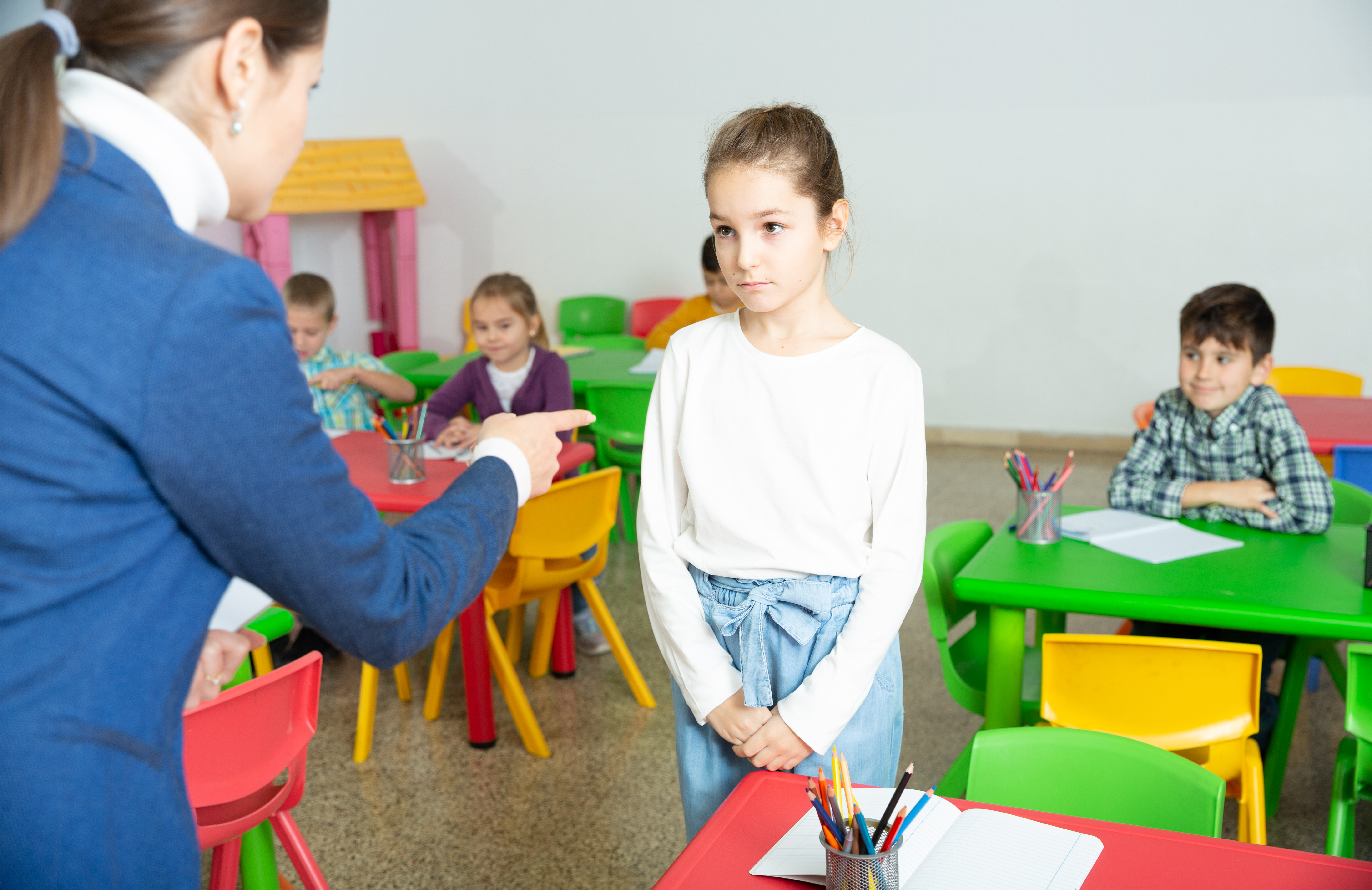 A teacher scolding a girl | Source: Shutterstock