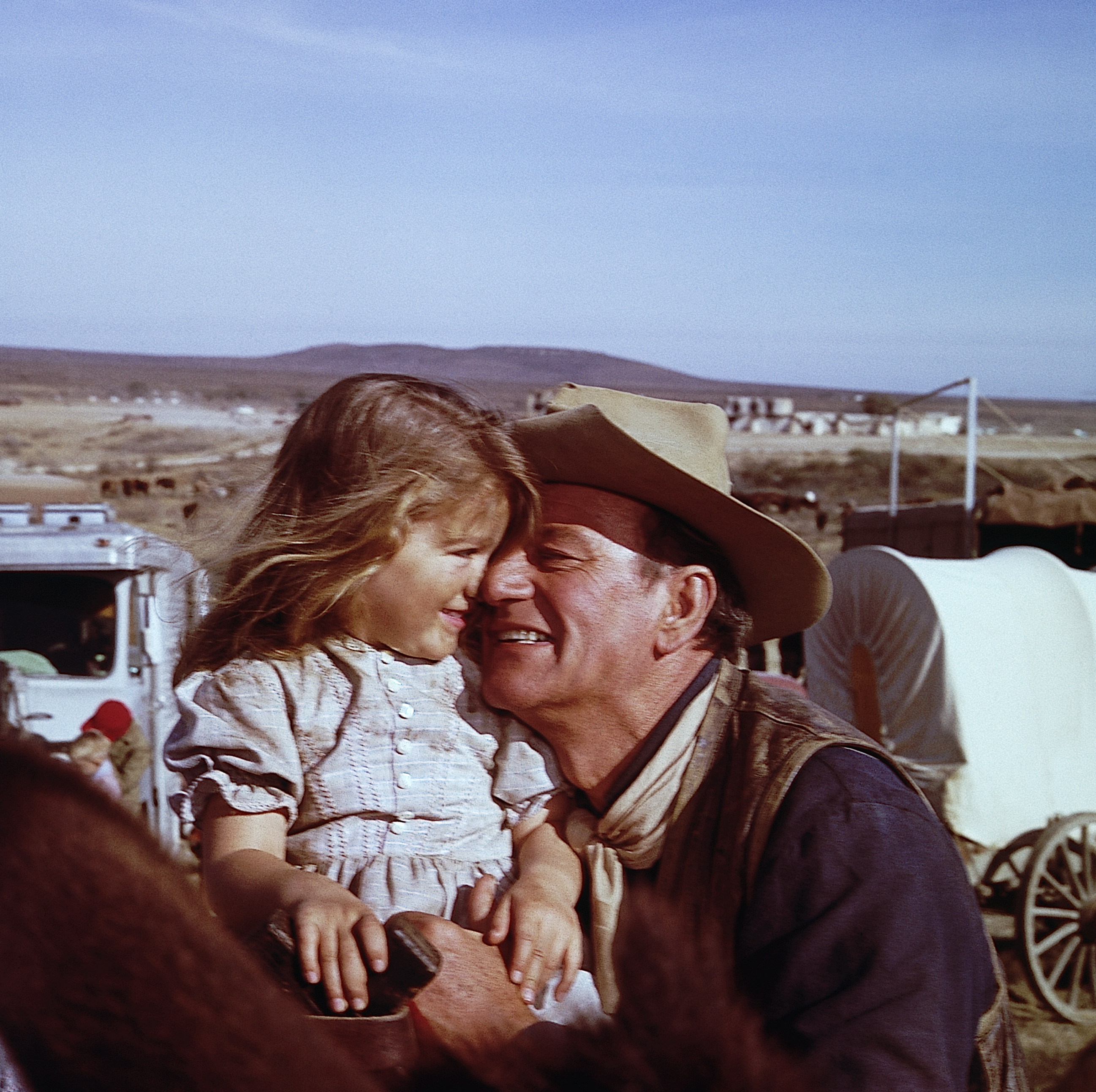 John Wayne and his daughter, Aissa, on the set of The Alamo at the "Happy" Shahan Ranch. | Source: Getty Images