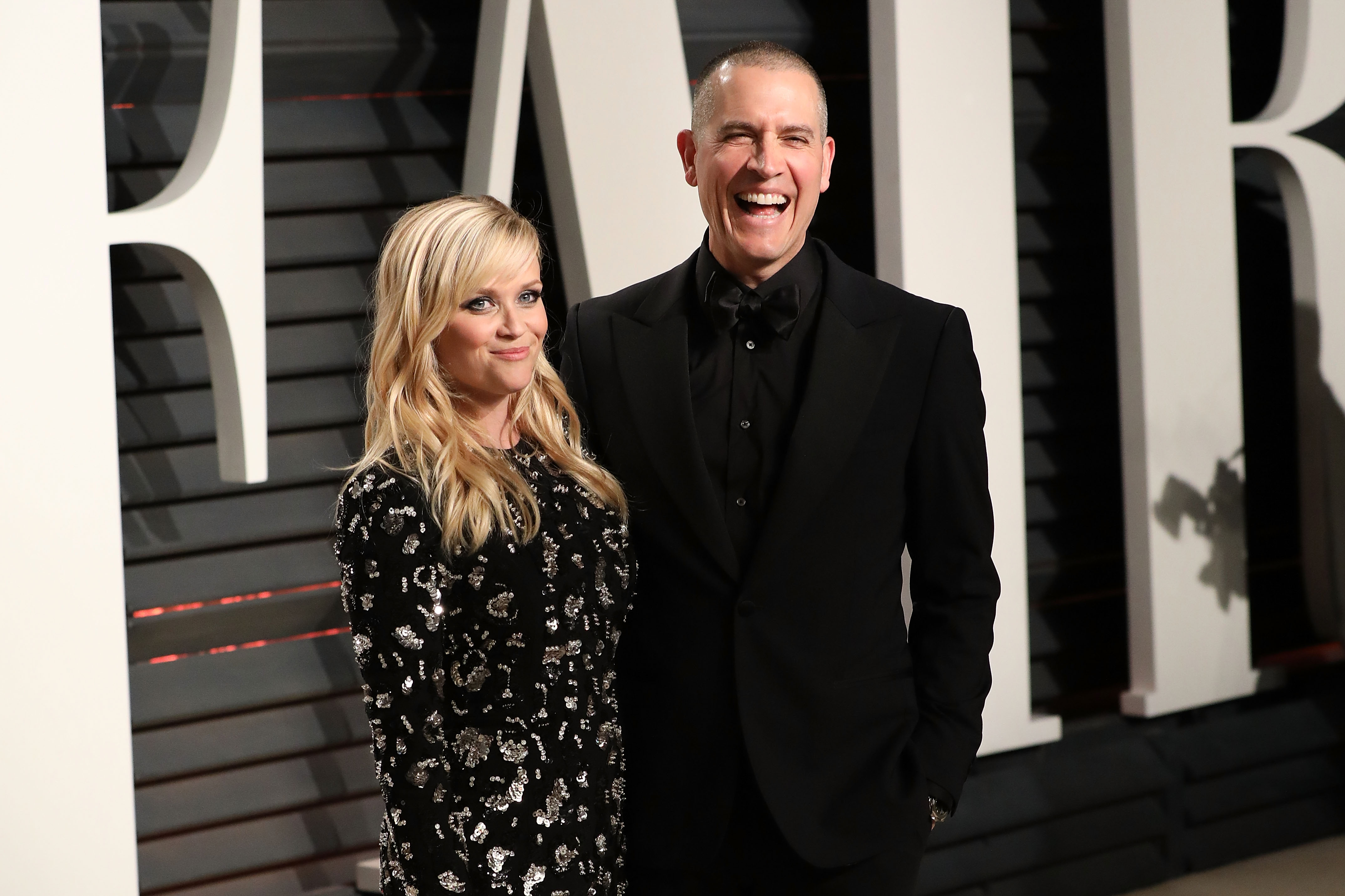 Witherspoon and Toth attend the 2017 Vanity Fair Oscar Party at the Wallis Annenberg Center for the Performing Arts in Beverly Hills, California. Witherspoon wears a slight smile as they pose for pictures while Toth is caught mid-laughter — they both look amazing together.