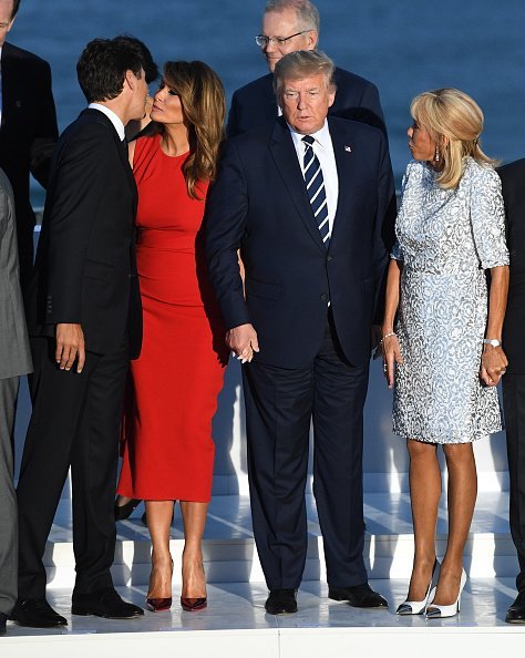 Canada's Prime Minister Justin Trudeau, US First Lady Melania Trump, US President Donald Trump, French President's wife Brigitte Macron about to pose together with other G7 leaders and guests at the annual G7 summit on August 25, 2019 in Biarritz, France | Photo: Getty Images