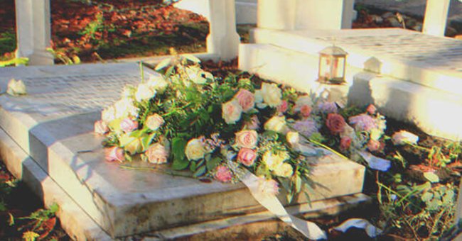 A grave covered in flowers | Source: Shutterstock