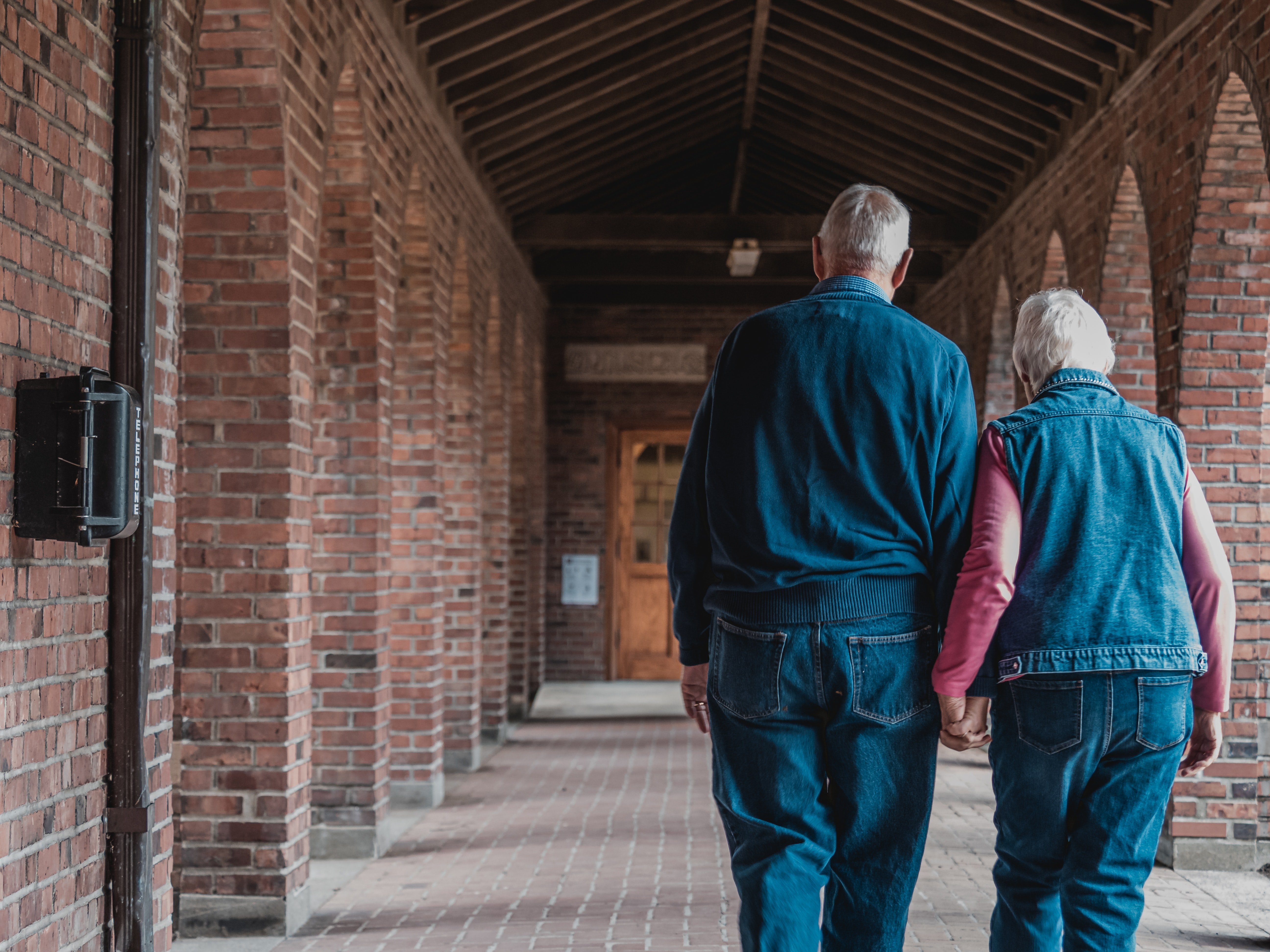 An elderly couple walking hand-in-hand. | Source: Pexels