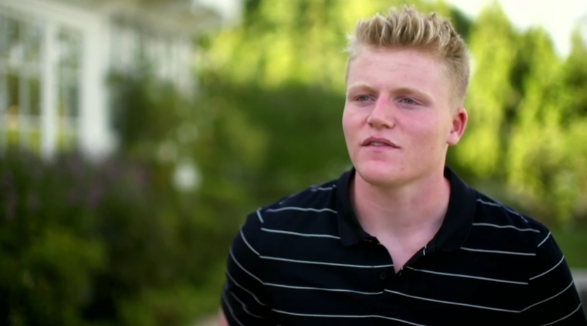 Jack Ramsay appeared in a reflective moment outdoors during an episode of the British docuseries "Born Famous," dated August 14, 2019. Wearing a casual striped polo, he spoke about his father's early life, offering a rare look into the contrast between his upbringing and Gordon's more modest beginnings. | Source: YouTube/Channel 4 Entertainment