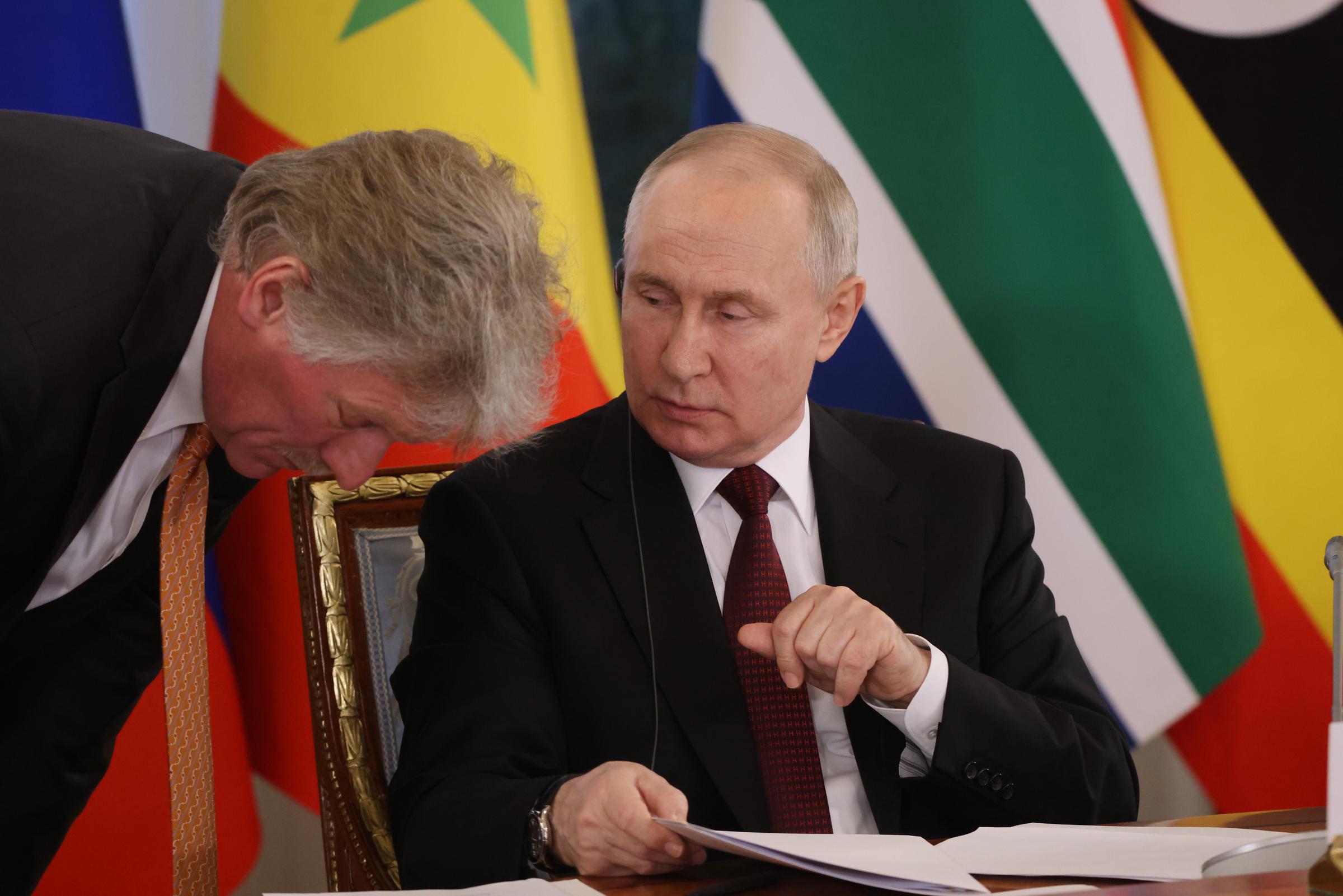 Vladimir Putin talks to his Press Secretary Dmitry Peskov during his meeting with African leaders at the Konstantin Palace in Strelna in Saint Petersburg, Russia, on June 17, 2023 | Source: Getty Images