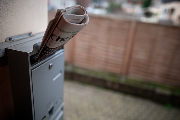 There's a newspaper stuck in a mailbox at one of the front doors | Photo: Getty Images