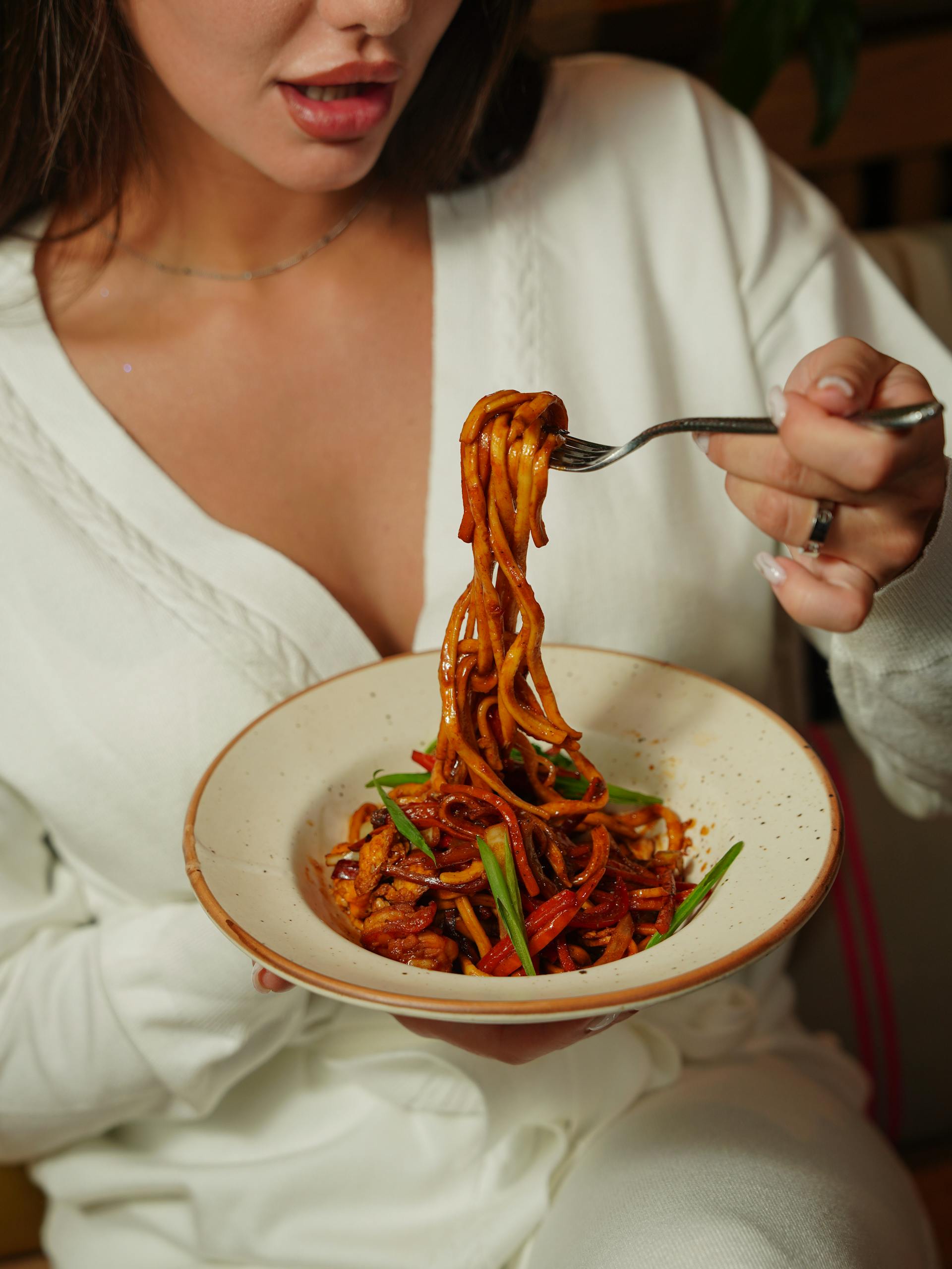 Woman eating pasta | Source: Pexels