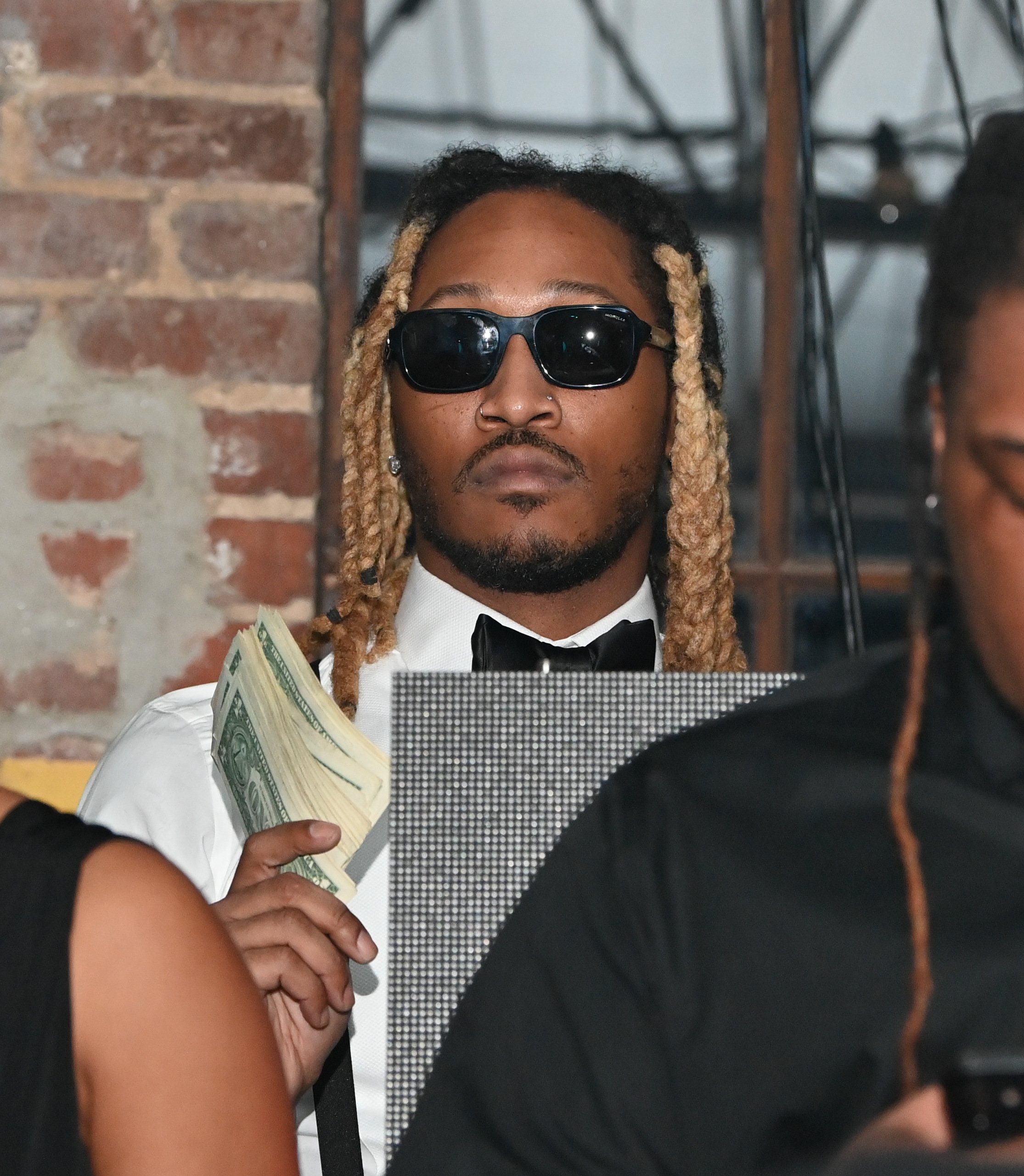 Future holding money at a Gentleman's Club in Atlanta, Georgia, on November 17, 2021. | Source: Getty Images