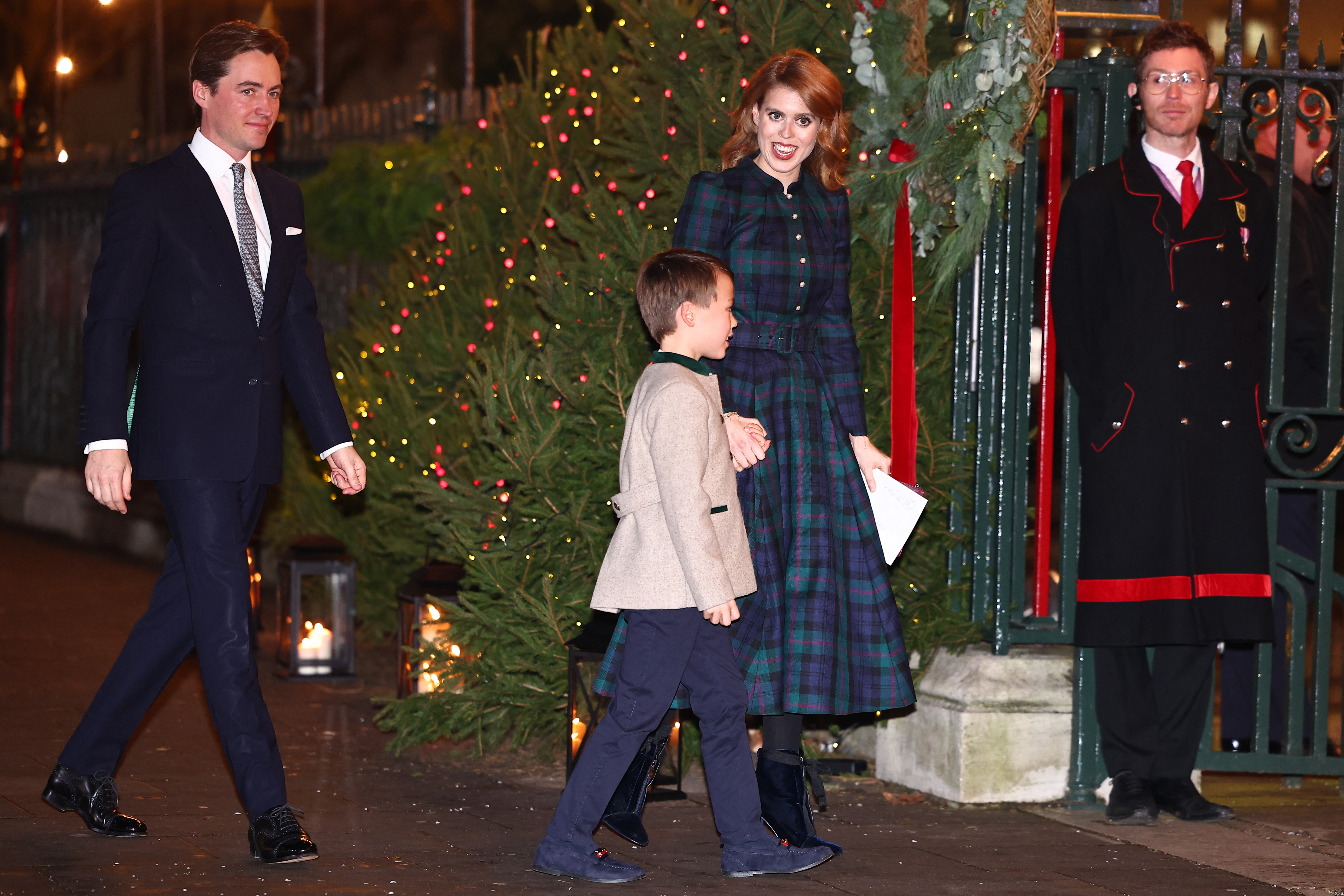 Edoardo Mapelli Mozzi walks behind Princess Beatrice of York, who is seen holding hands with her stepson Christopher Woolf Mapelli Mozzi as they attend the "Together At Christmas" Carol Service at Westminster Abbey on December 8, 2023, in London. | Source: Getty Images