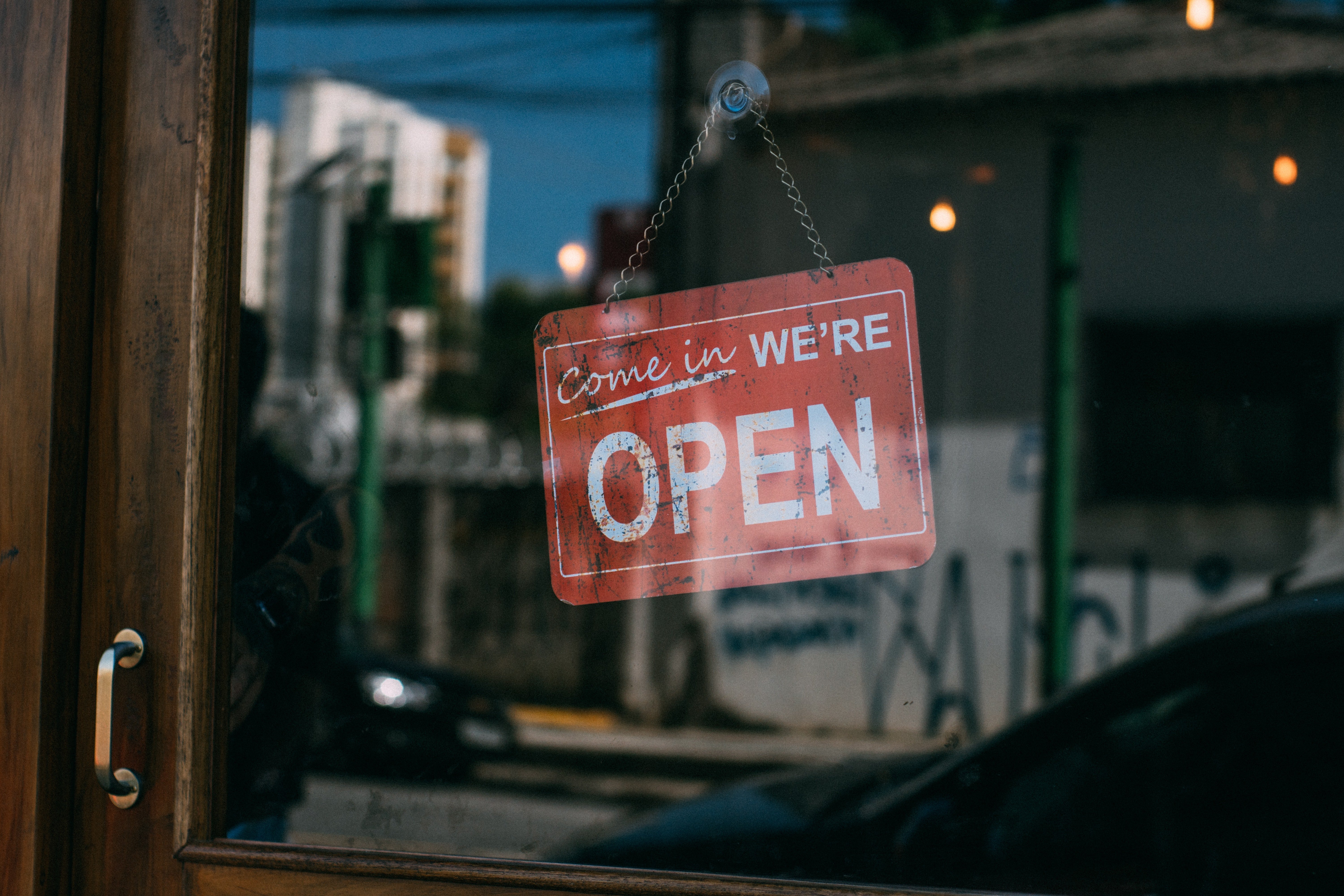 A "we're open" sign on the door of a store. | Photo: Pexels
