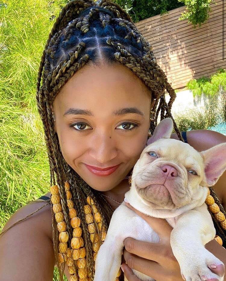 Naomi Osaka smiling for a photo with her dog, posted on July 2, 2021. | Source: Facebook/Naomi Osaka 大坂なおみ﻿