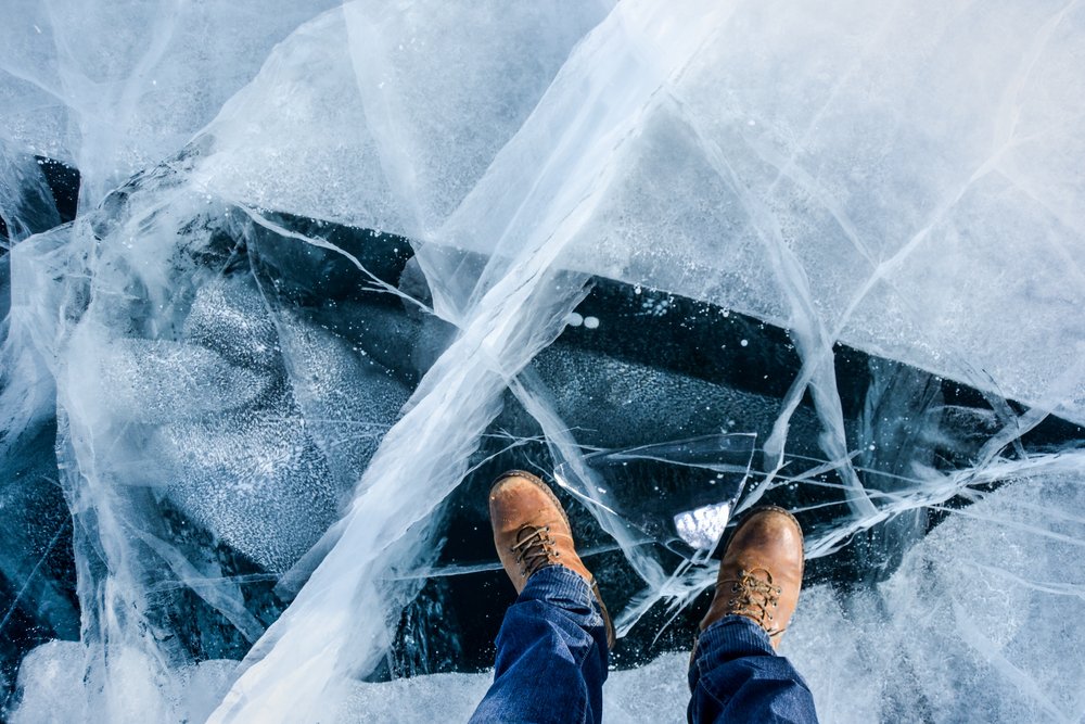 A photo of a man's feet on a frozen lake | Photo: Shutterstock