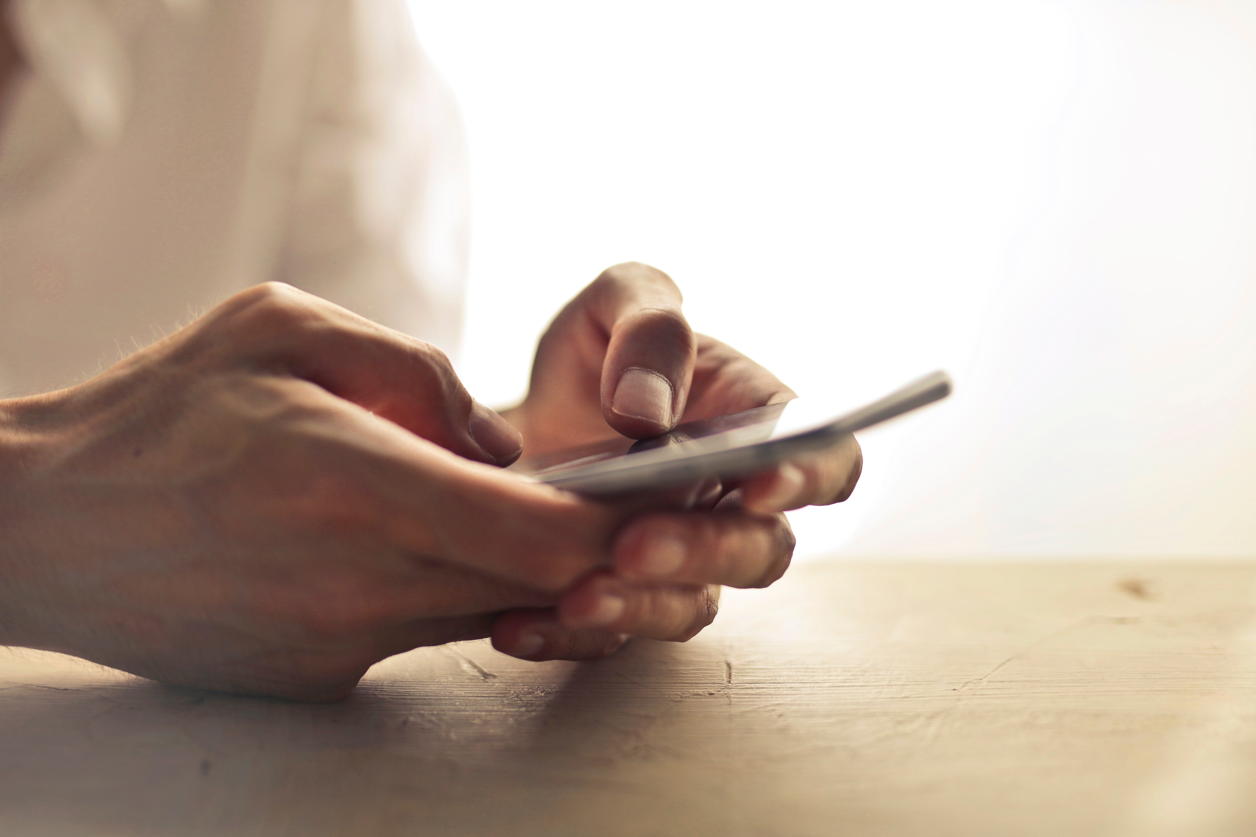 A photo of a man holding a phone. | Photo: Pexels