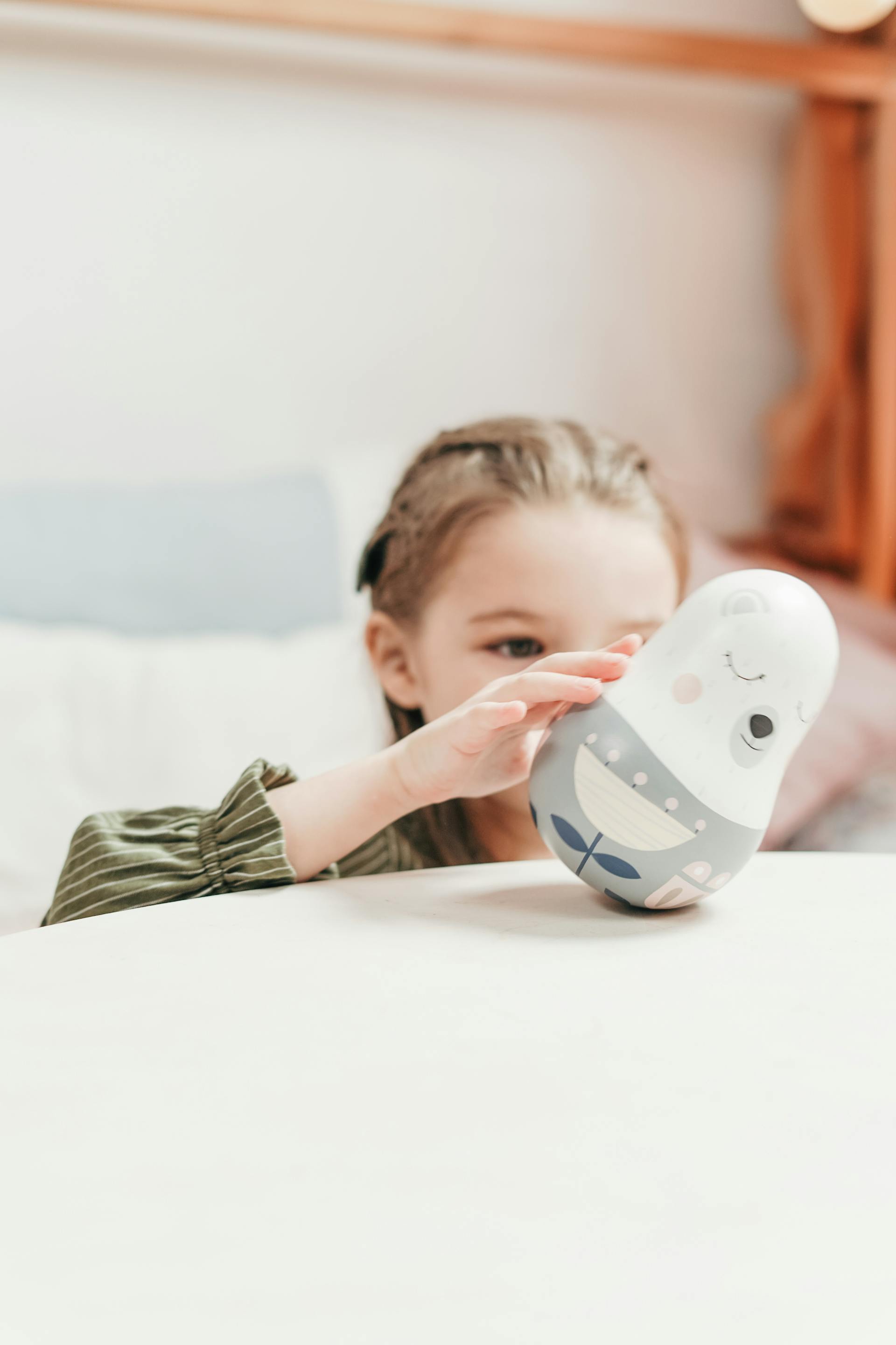 A little girl playing with a plush toy | Source: Pexels