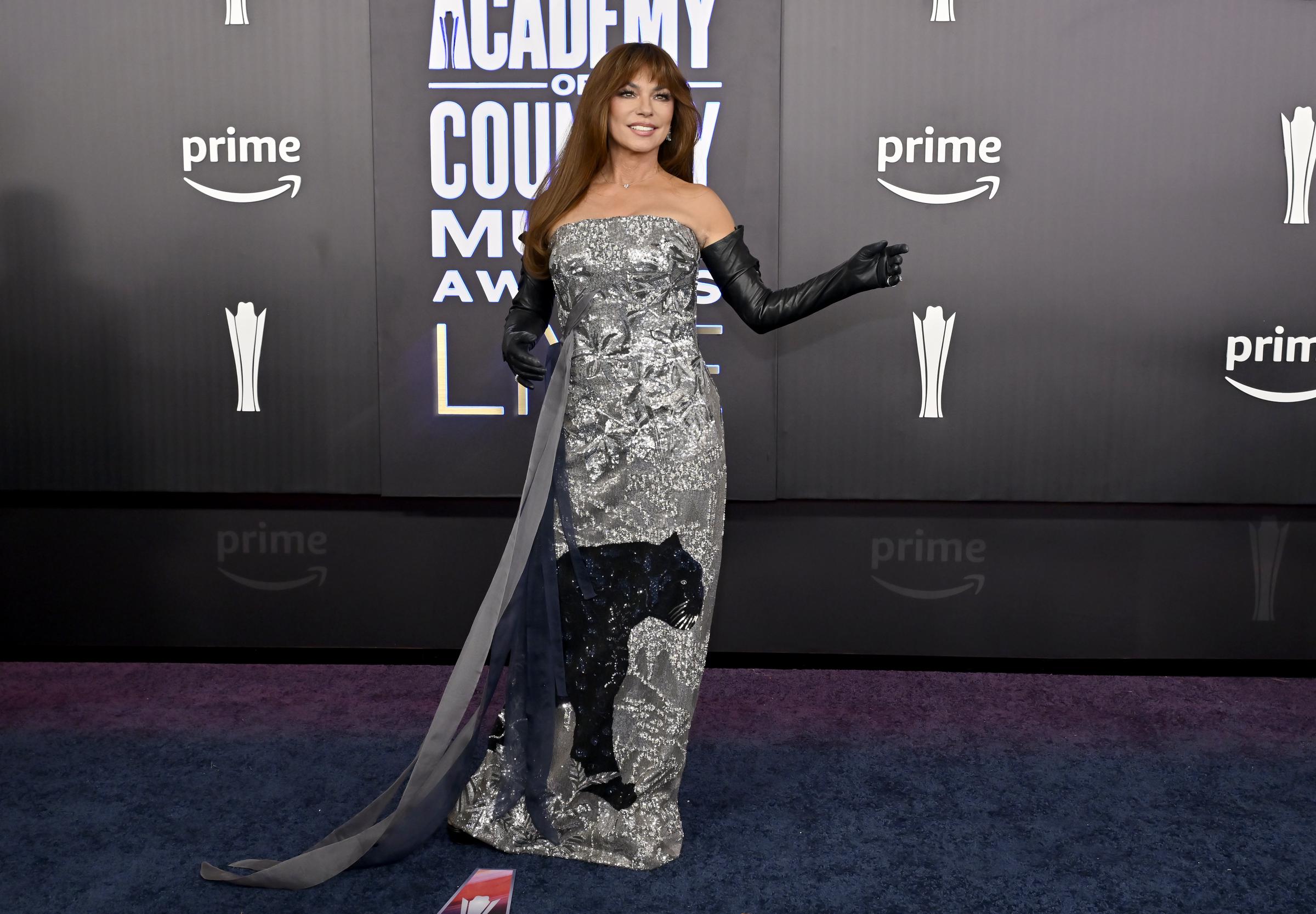 Long black gloves and shimmering textures added dramatic flair to Shania Twain's red carpet ensemble | Source: Getty Images