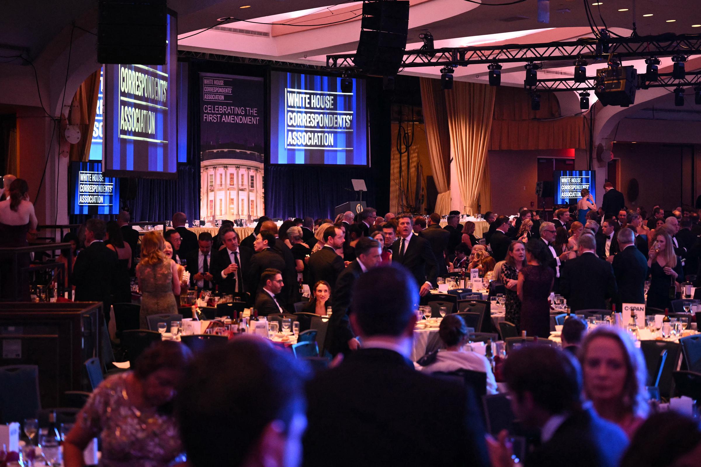 Attendees take cover inside the ballroom after gunshots were fired during the White House Correspondents' Dinner at Washington Hilton on April 25, 2026, in Washington, DC | Source: Getty Images