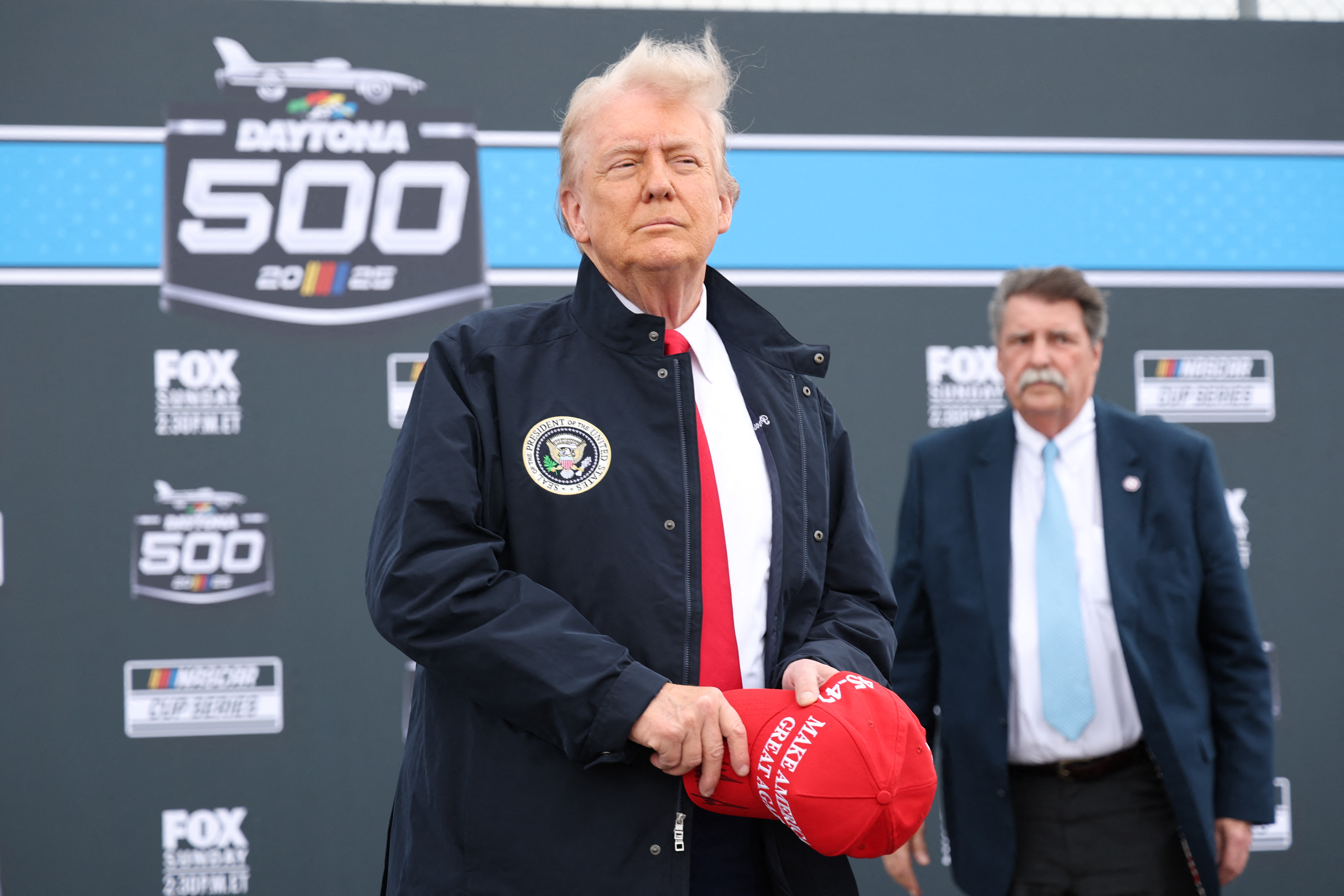 Donald Trump during the national anthem prior to the race on February 16, 2025, in Daytona Beach, Florida. | Source: Getty Images