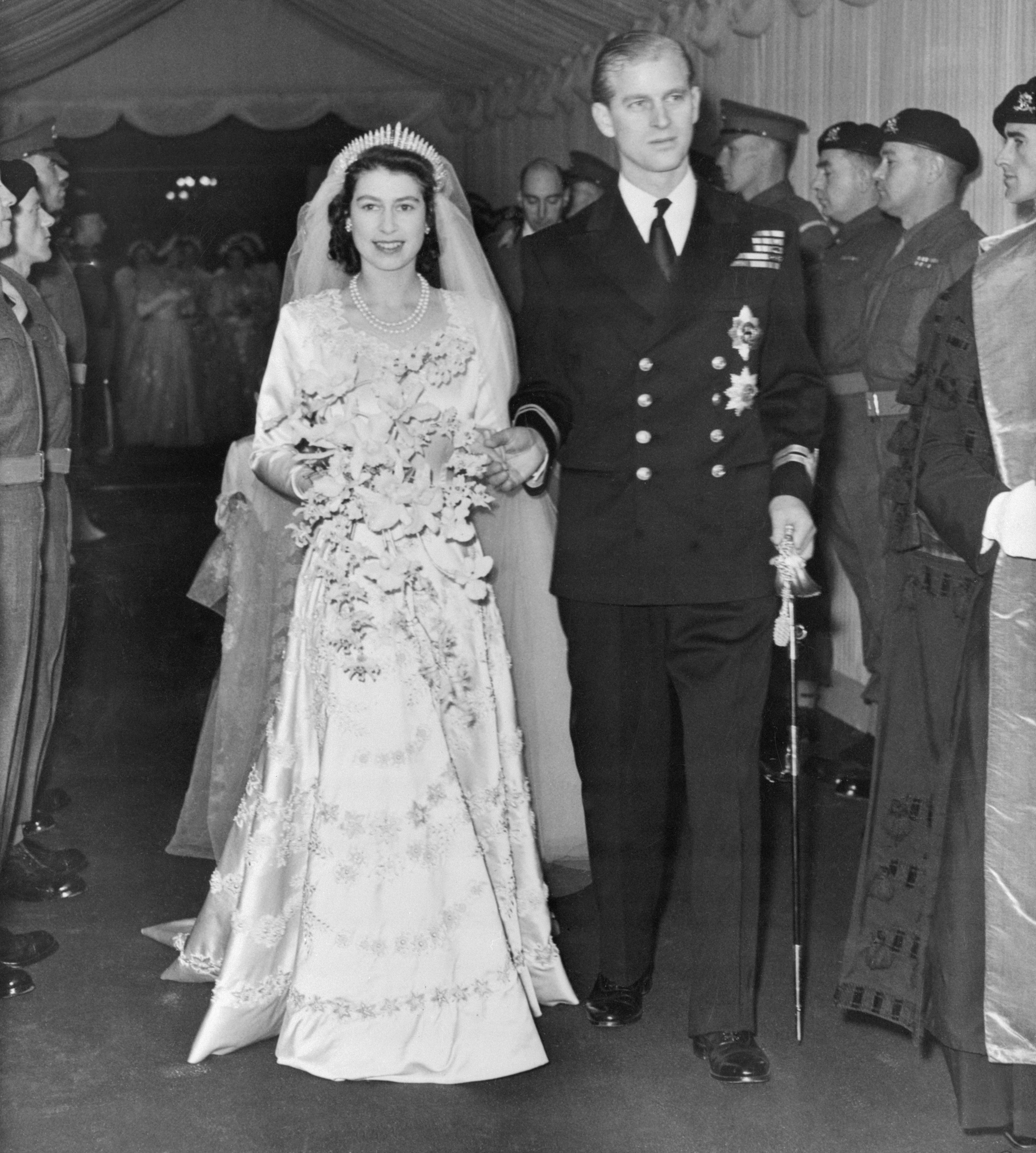 Princess Elizabeth and Prince Philip after getting married walking down the aisle of Westminster Abbey, London, on November 21, 1947 | Source: Getty Images
