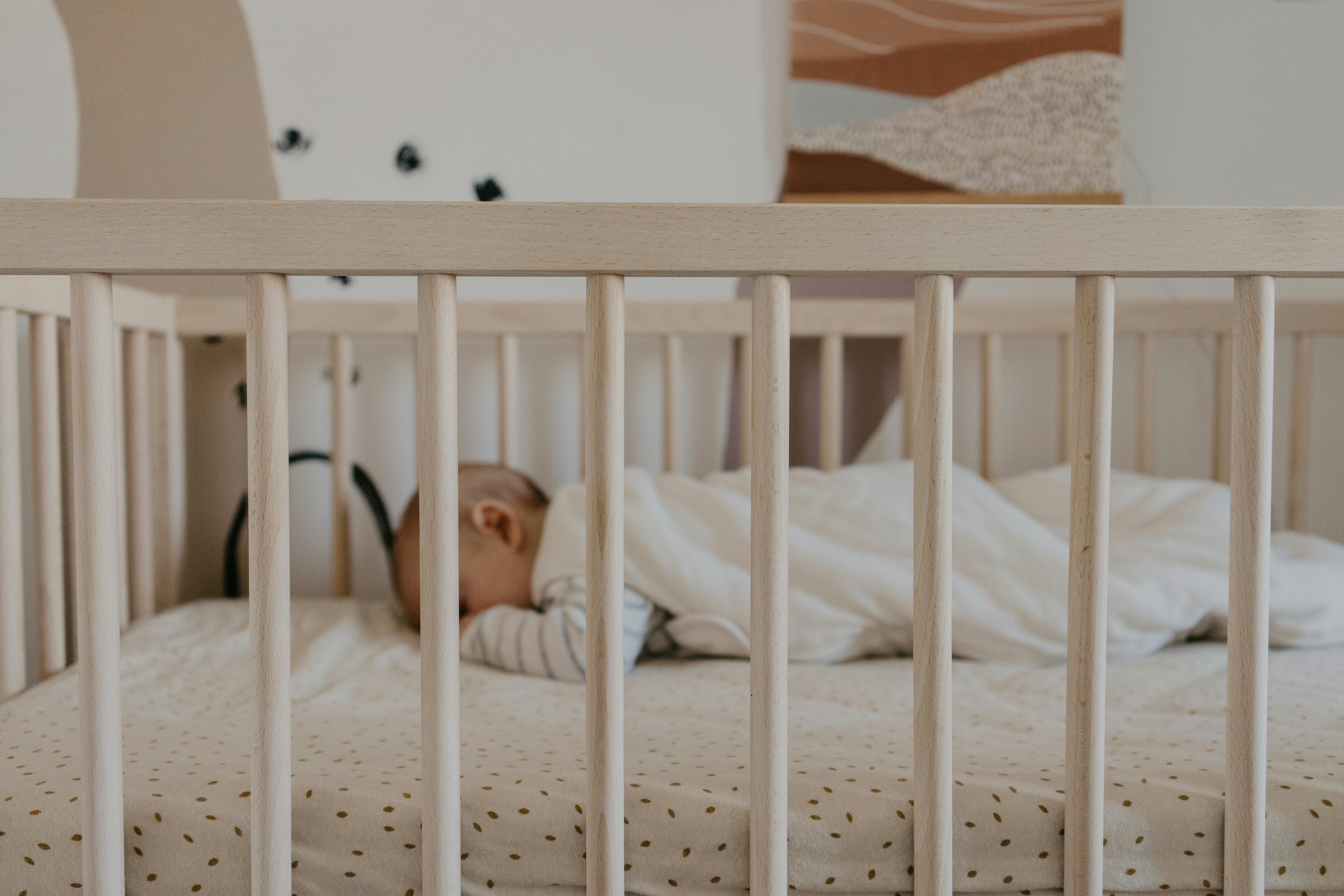 A baby sleeping in a crib | Source: Unsplash