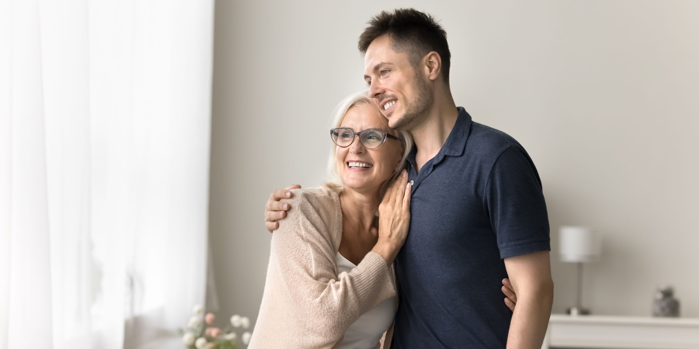 A happy couple comprising of a younger man and an older woman | Source: Shutterstock