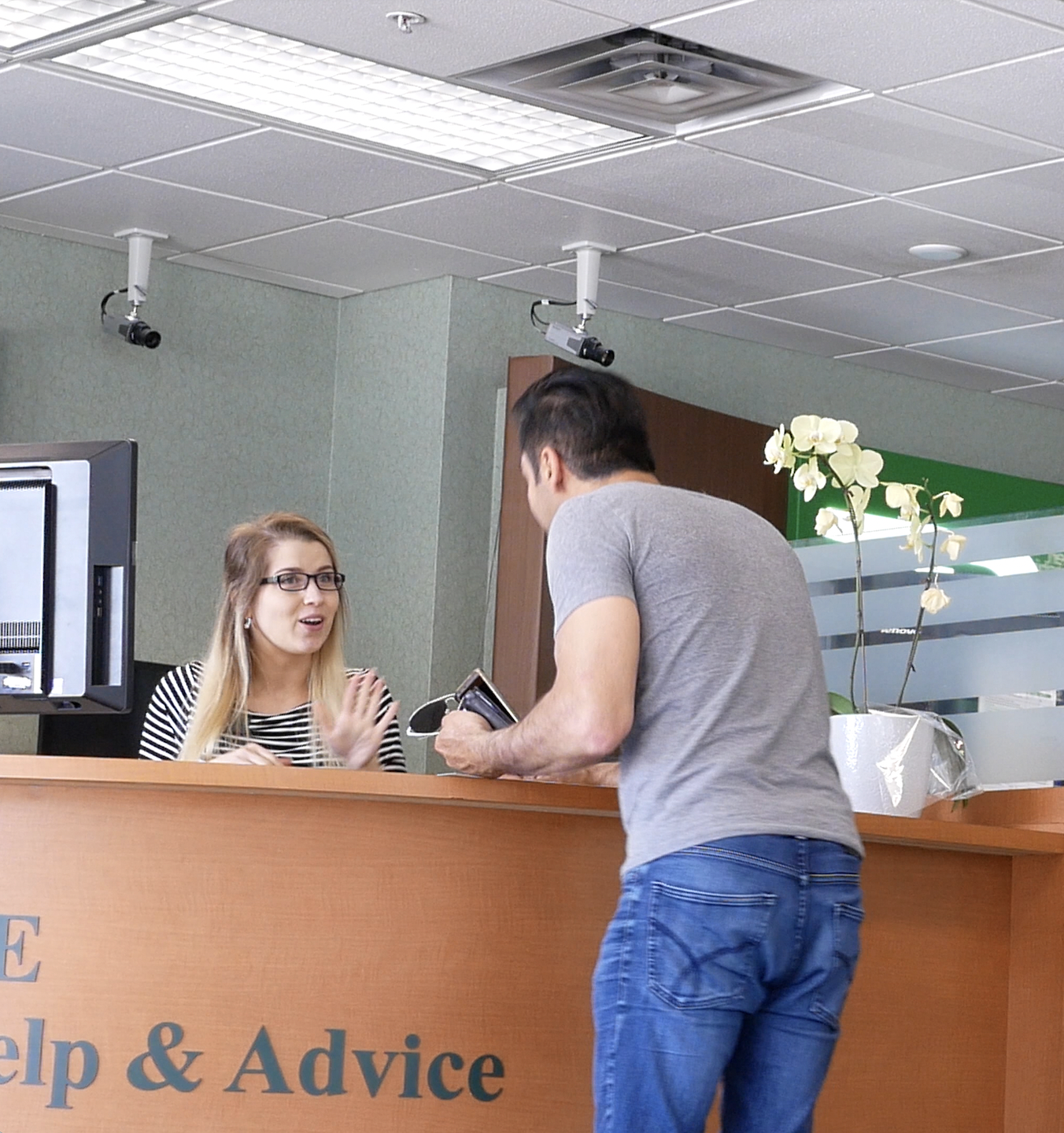 Man is standing is standing by the customer assistance in the bank | Source: Shutterstock.com