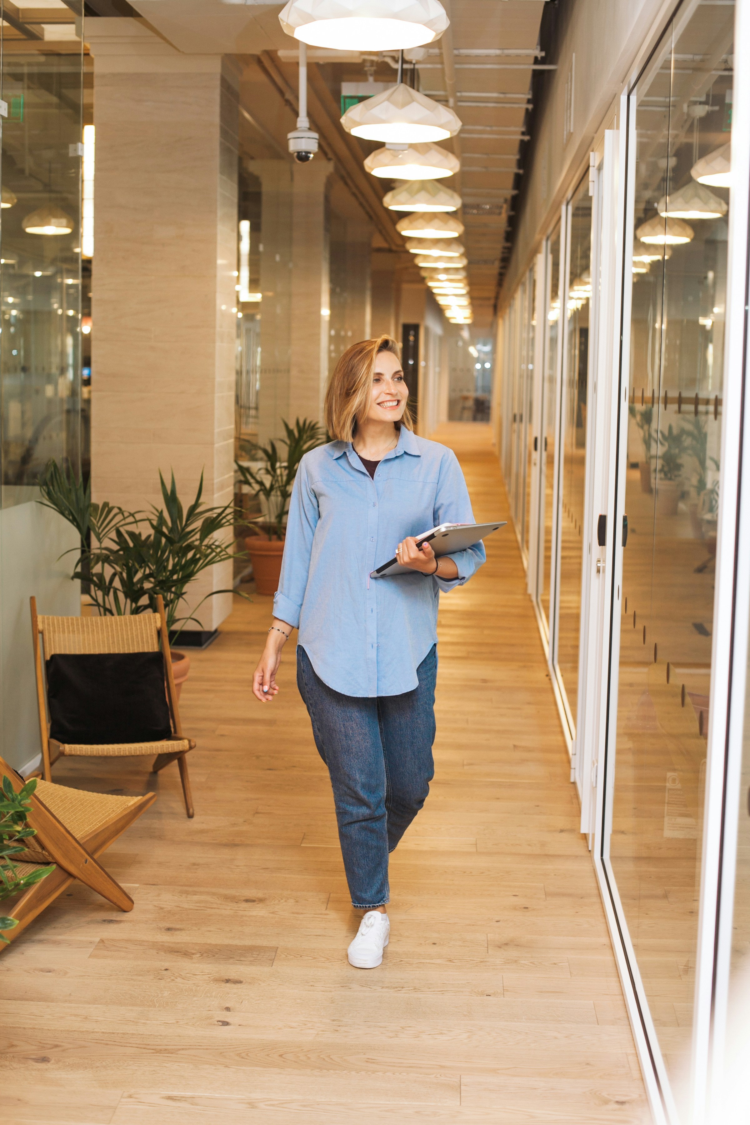 A female businesswoman walking in the office corridor | Source: Unsplash