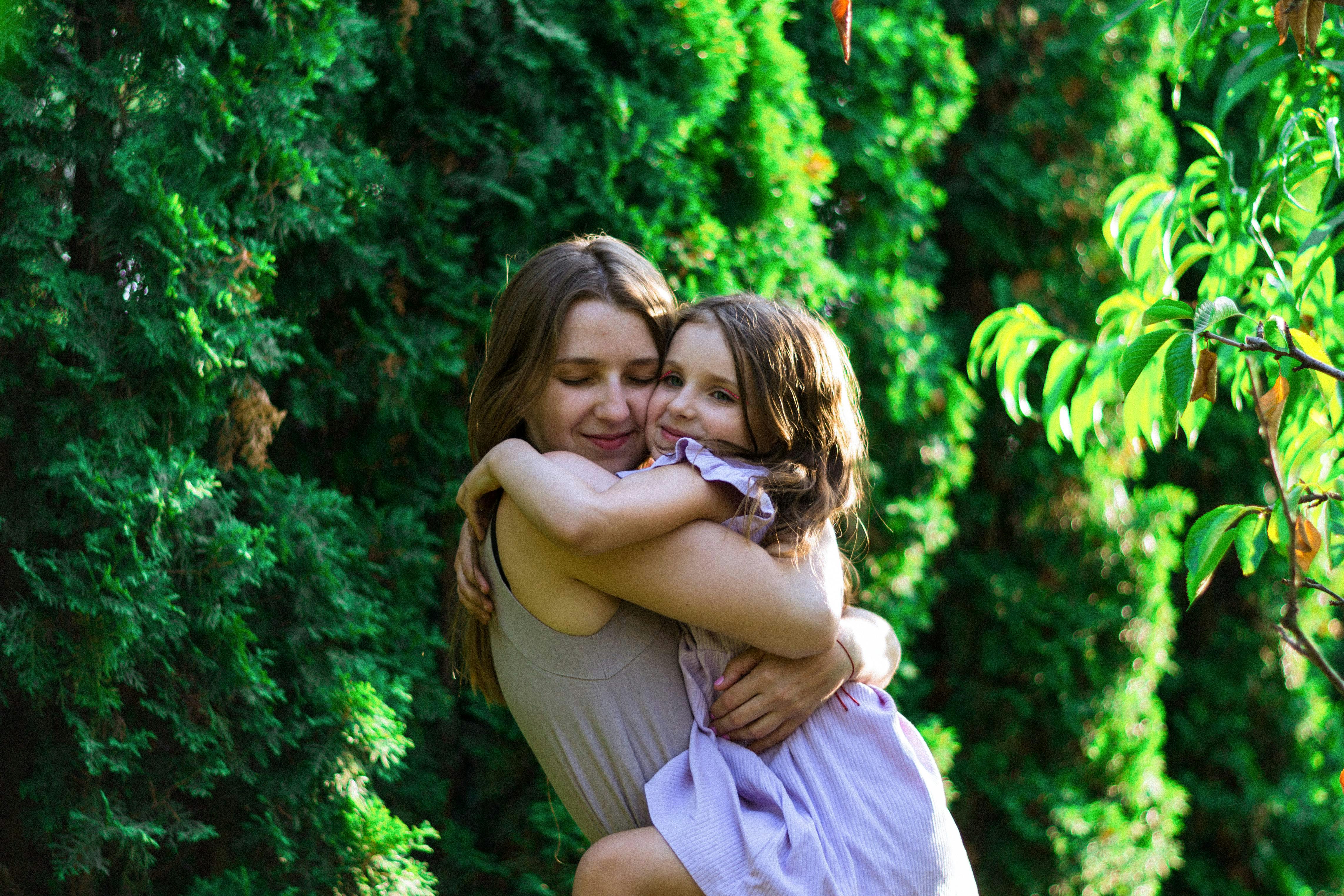 A mother warmly embracing her daughter | Source: Pexels