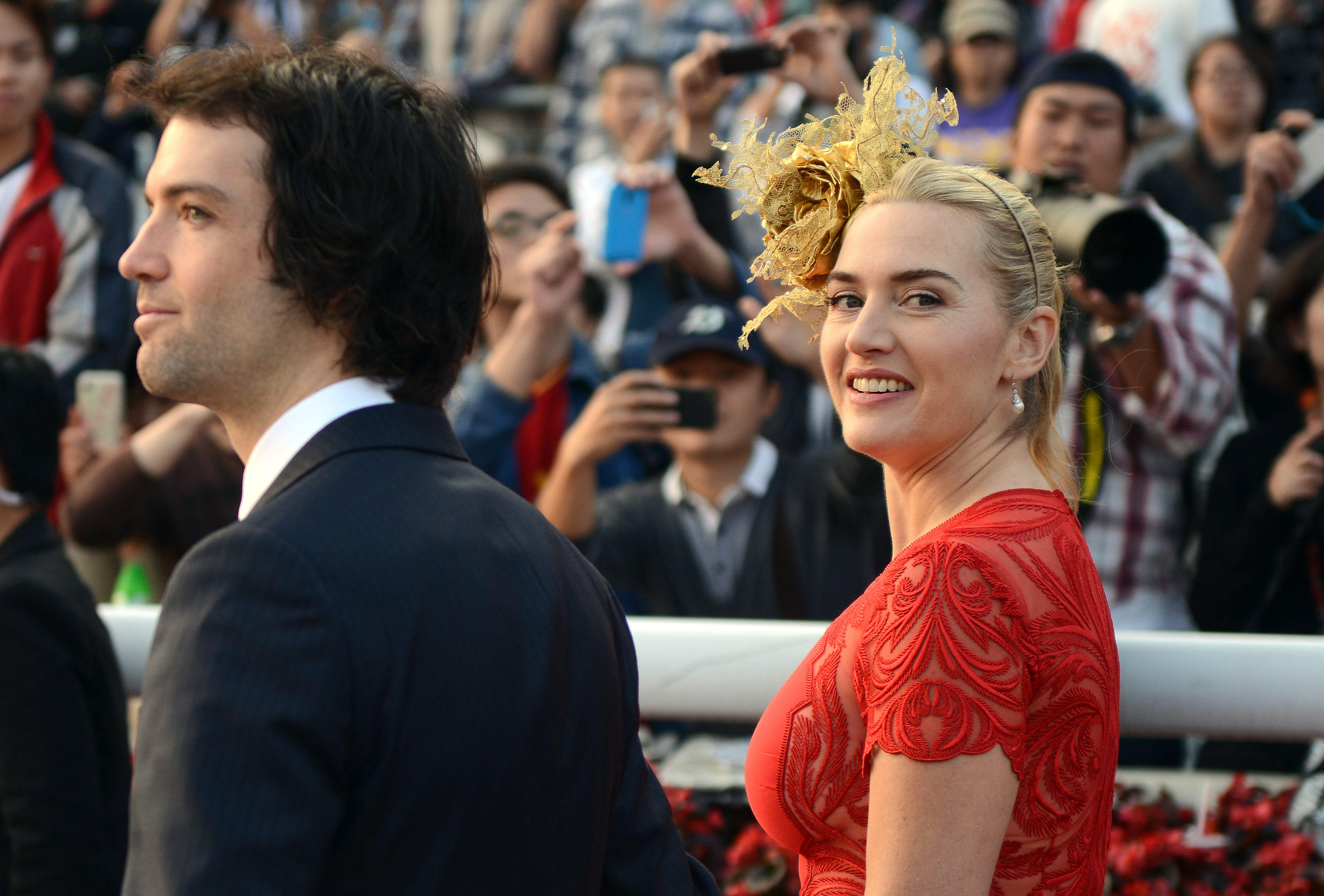 Kate Winslet and Ned Rocknroll walk together after the presentation ceremony for the 2,000-metre Longines Hong Kong Cup race at the Hong Kong International Races at the Shatin racecourse in Hong Kong. | Source: Getty Images