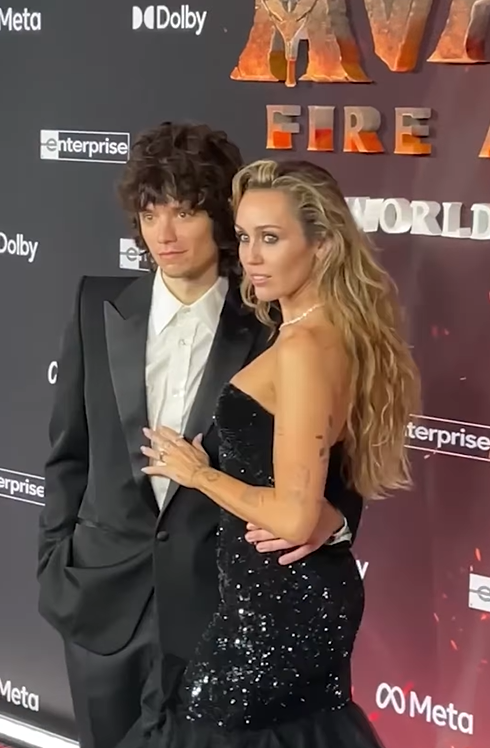 Miley Cyrus and Maxx Morano pose for pictures on the red carpet, as seen from a post dated December 1, 2025. | Source: Instagram/enews