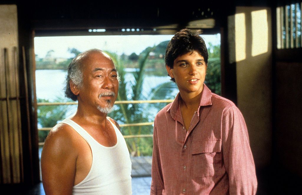 Pat Morita and Ralph Macchio during a scene from the film 'The Karate Kid', 1984. | Source: Getty Images
