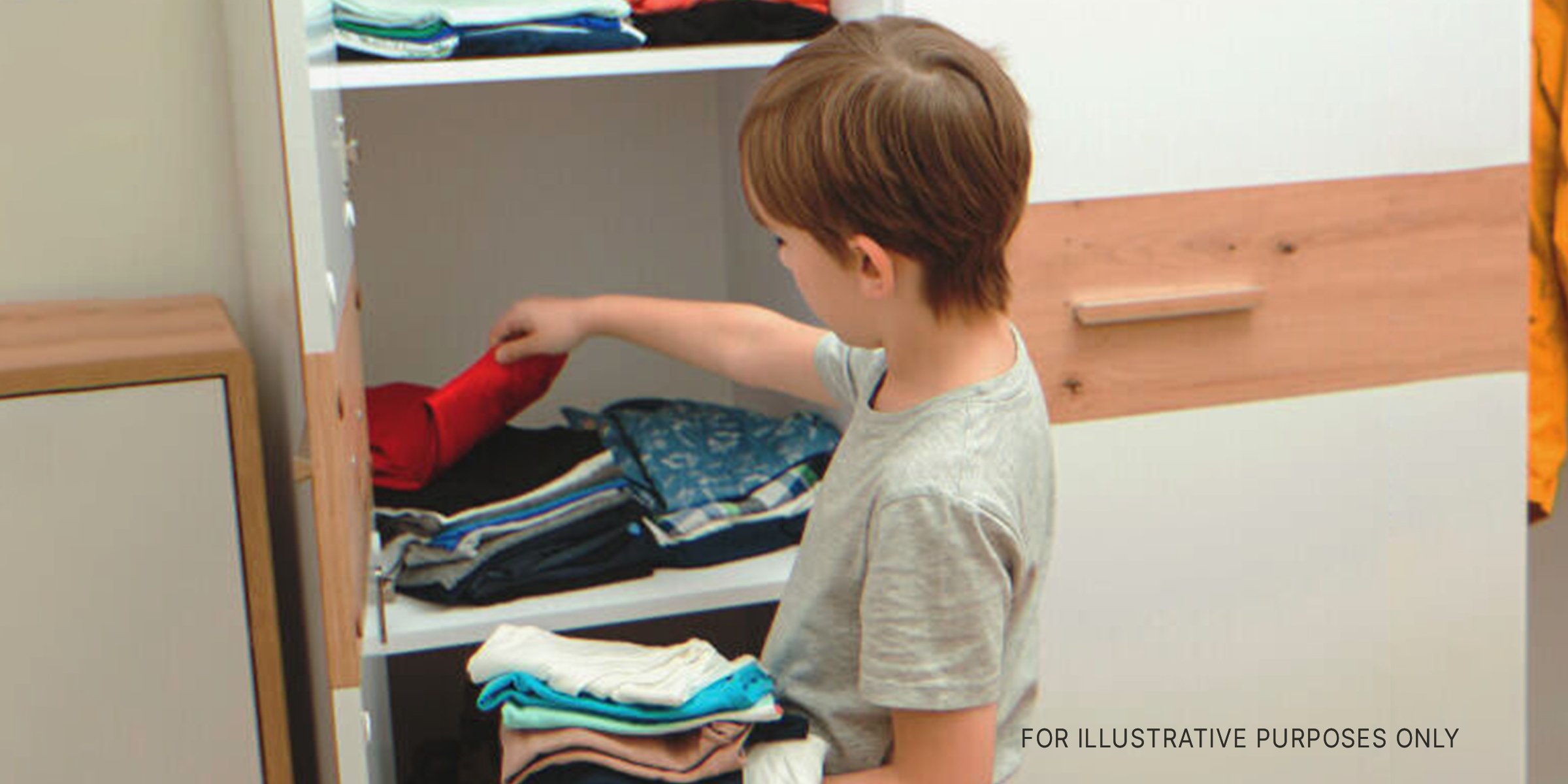 Boy looking in closet | Source: Shutterstock